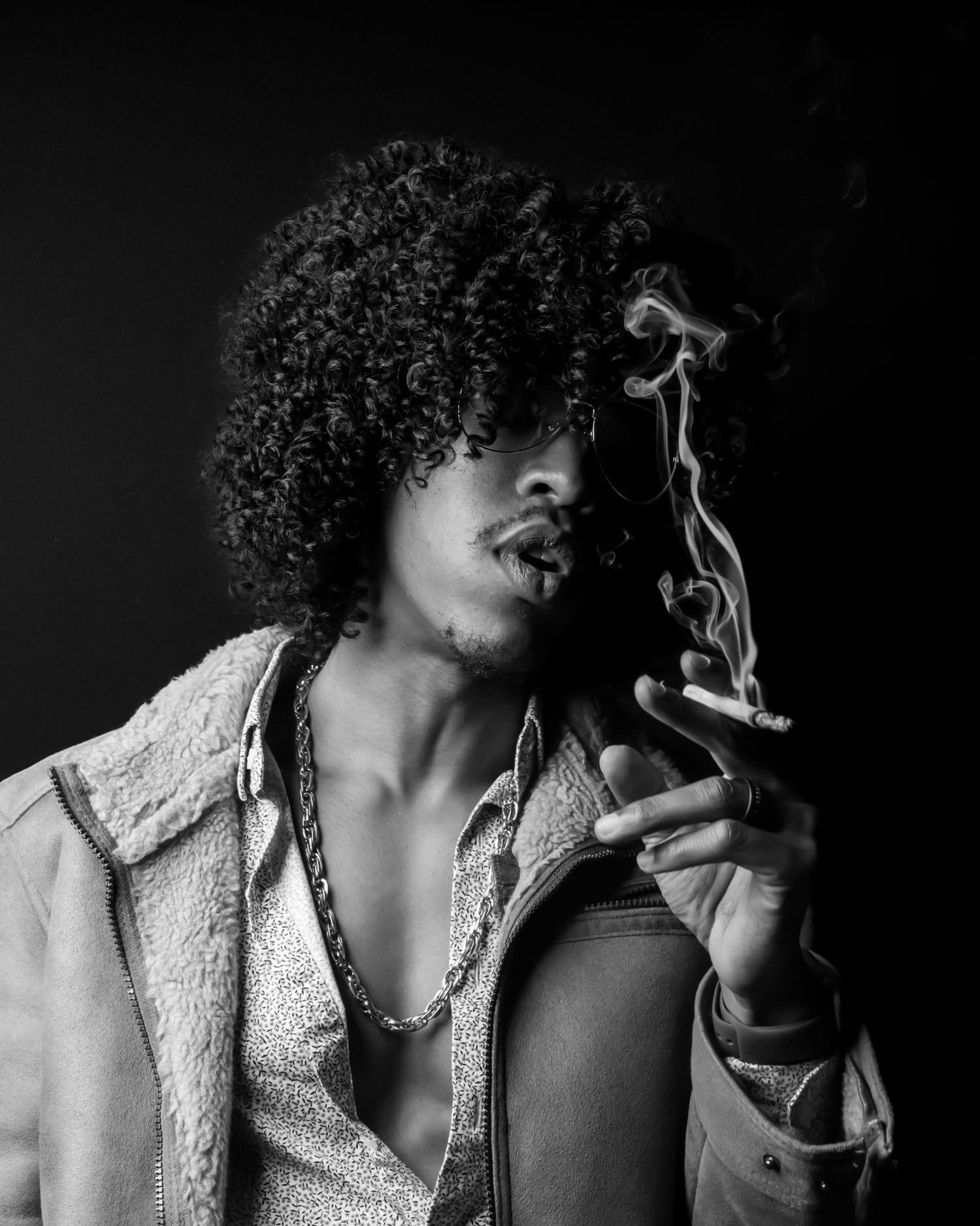 Black and white portrait series showing person in sherpa jacket with smoke effects.