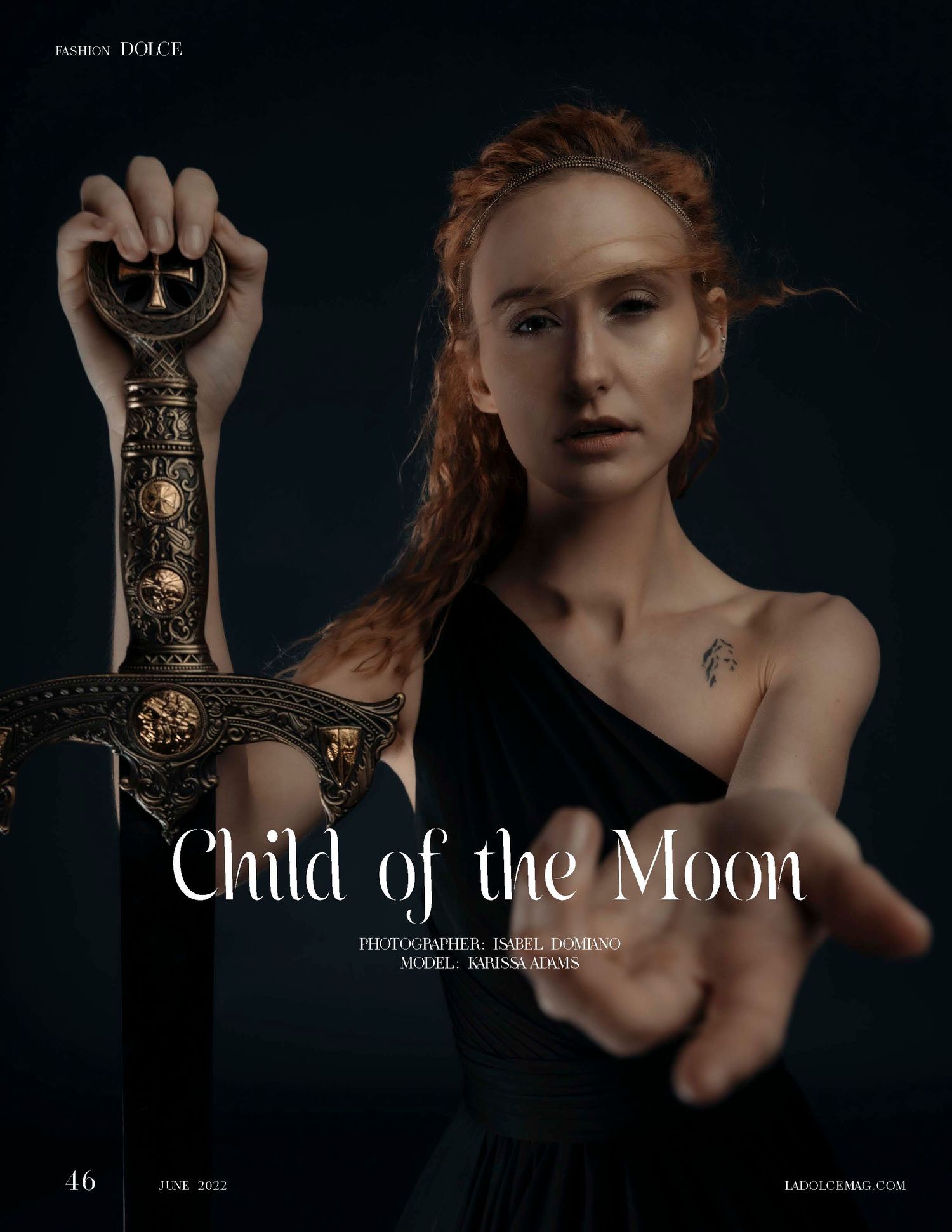 Redhead model holds ornate sword in dramatic dark editorial shoot for Dolce Magazine June 2022 Child of the Moon.