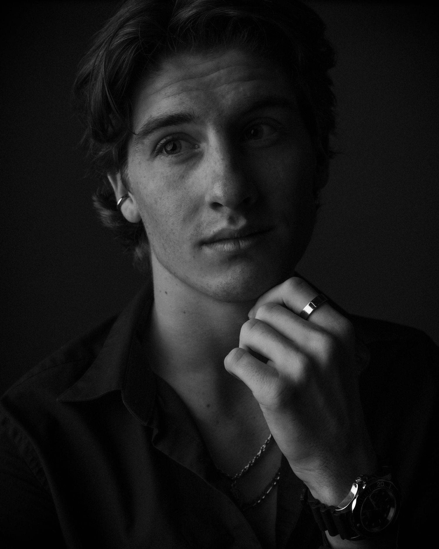 Moody black and white portrait series showing contemplative expressions.