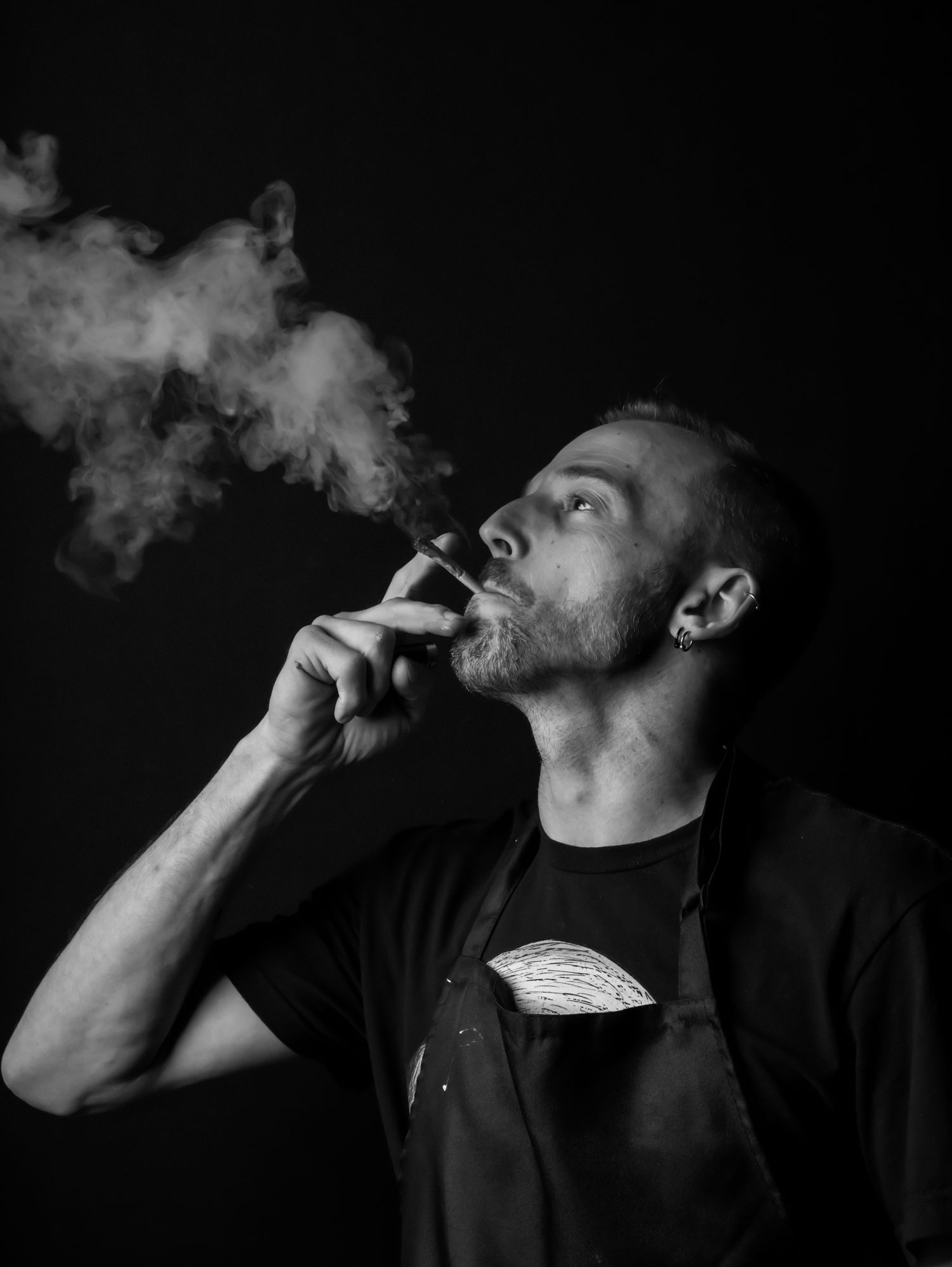 Artistic black and white photos showing smoke exhaled in dramatic lighting.