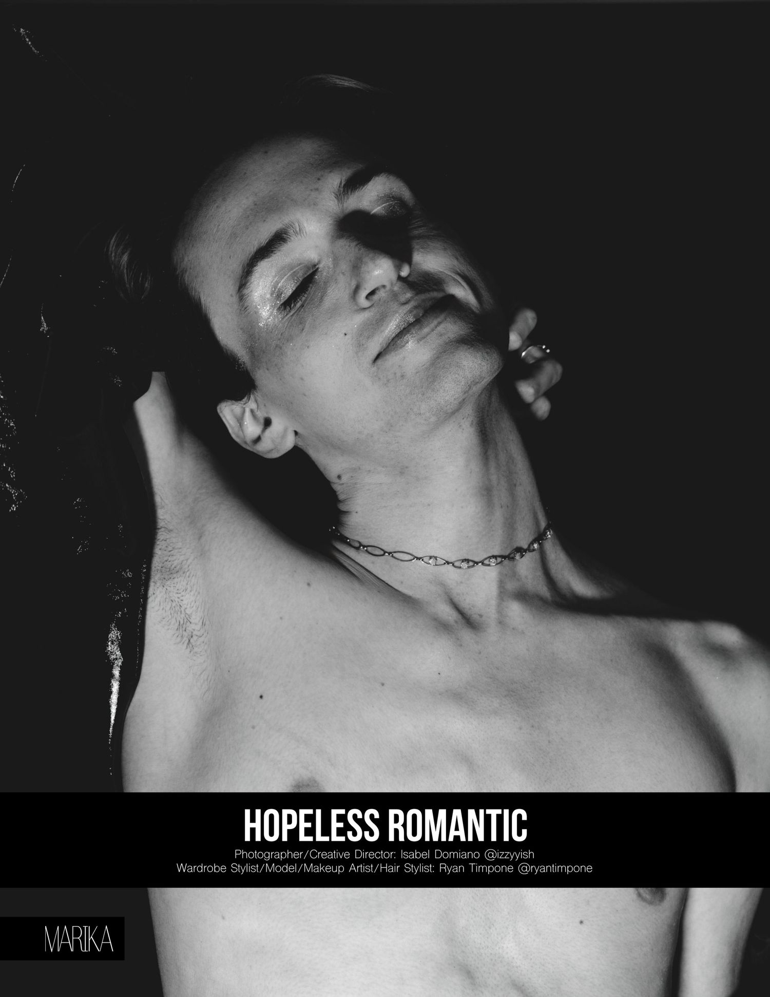Black and white fashion editorial photo of shirtless male model with chain necklace, titled Hopeless Romantic.