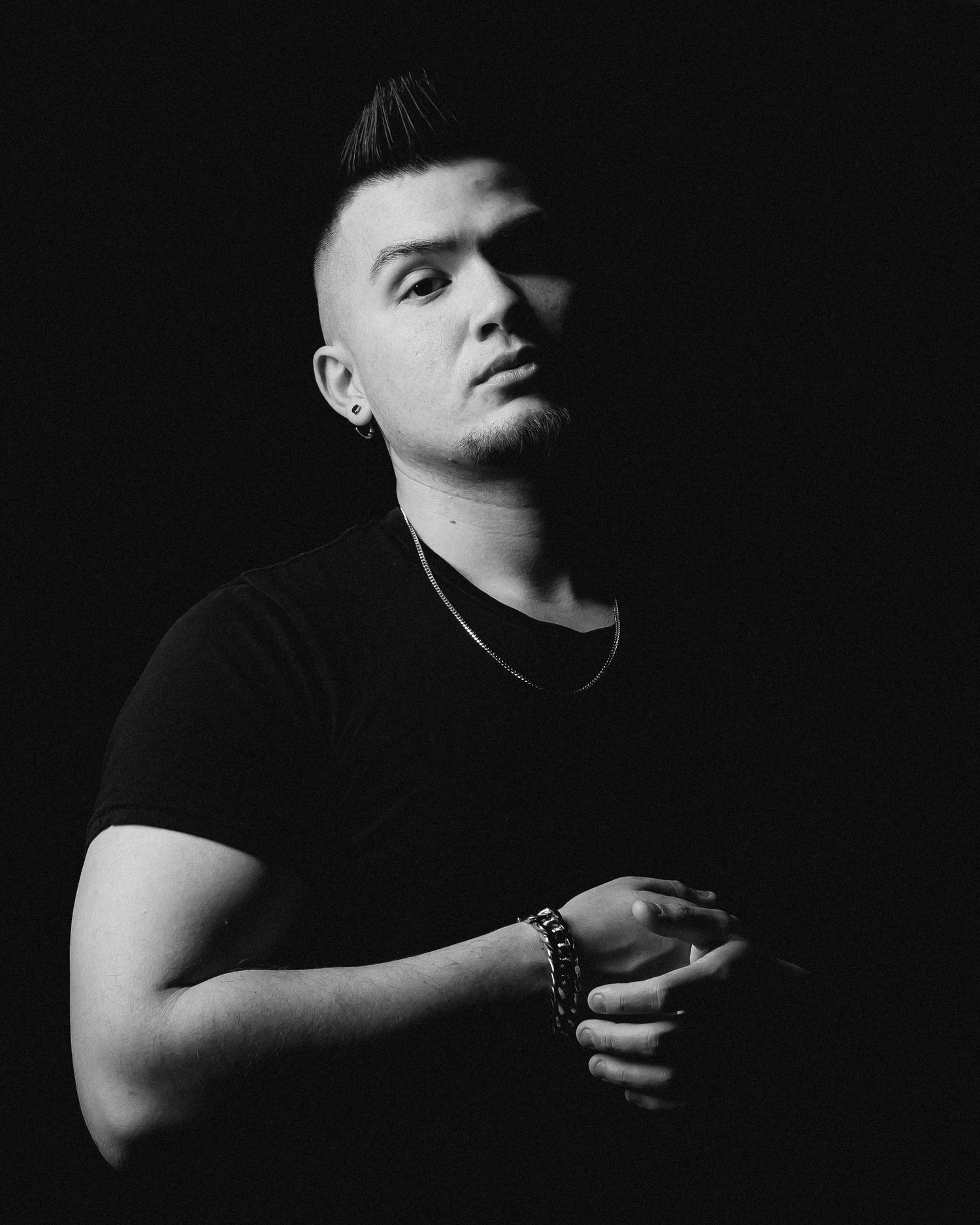Minimalist black and white portrait series with dramatic side lighting.