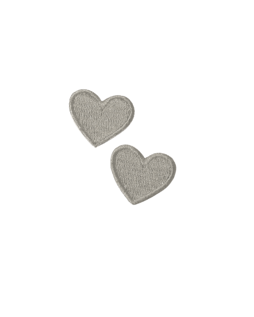 Two small silver embroidered heart-shaped patches on white background.