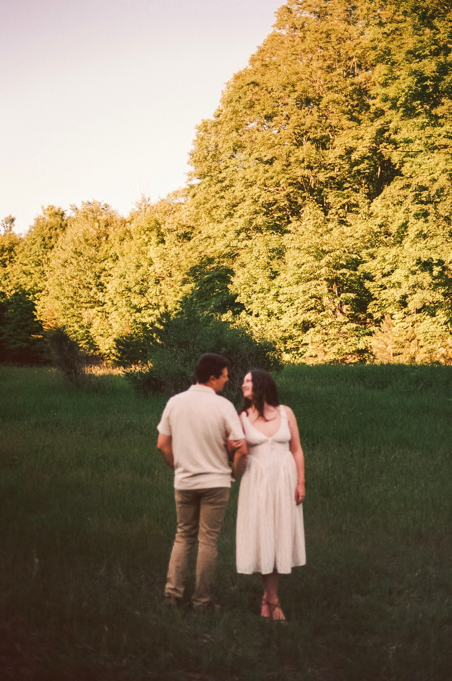 Romantic gentle summer engagement on 35MM film photographer northern Indiana candid documentary true to life golden sunlight lush greens