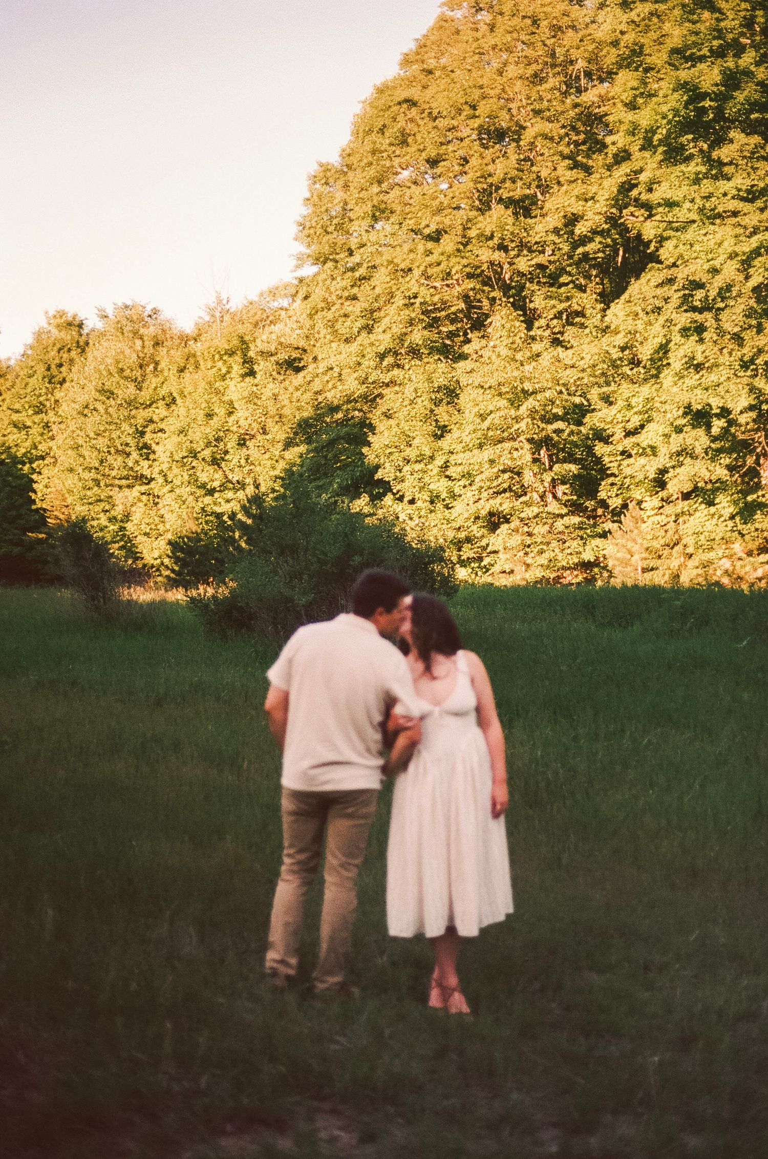Romantic gentle summer engagement on 35MM film photographer northern Indiana candid documentary true to life golden sunlight lush greens