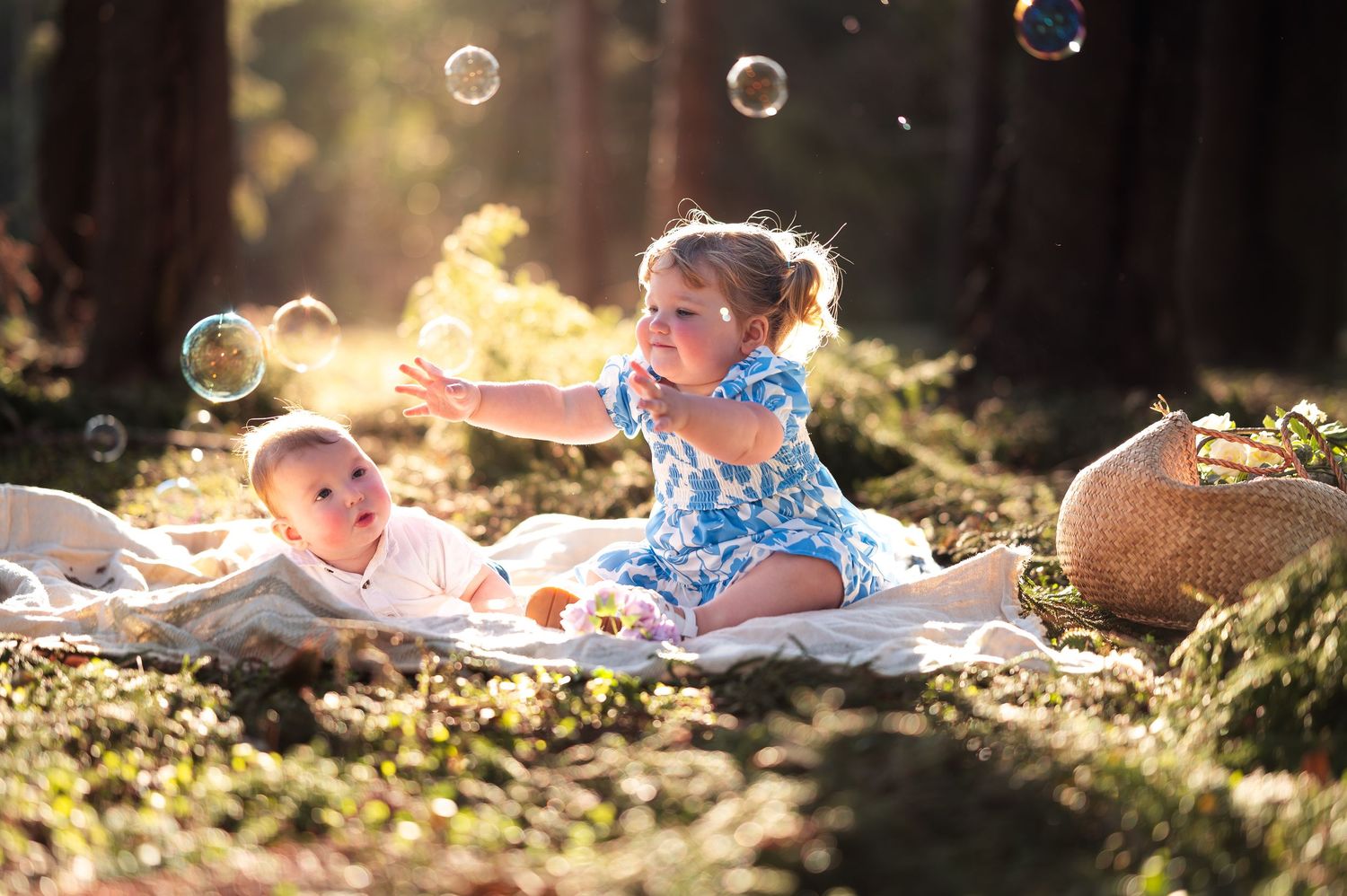 Family playing with bubbles during sunset photoshoot in nature.