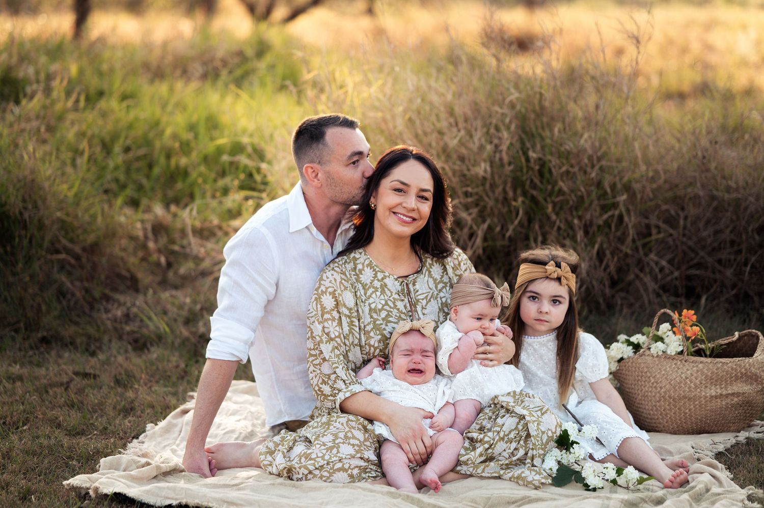 Family portrait session at sunset with warm tones and coordinated outfits.