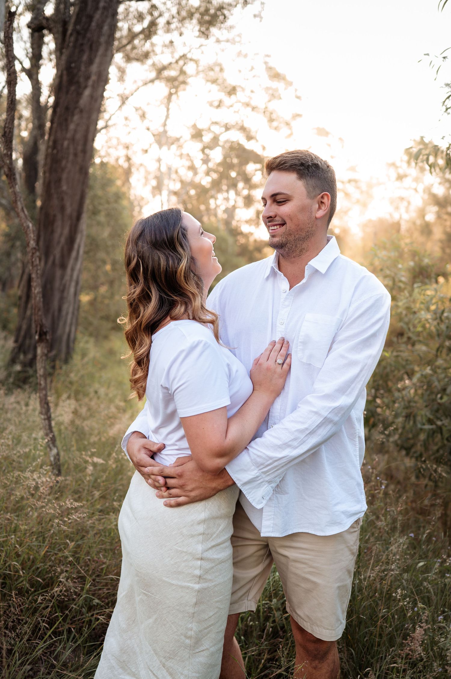 Candid sequence showing laughter and embraces in a sunlit woodland setting.