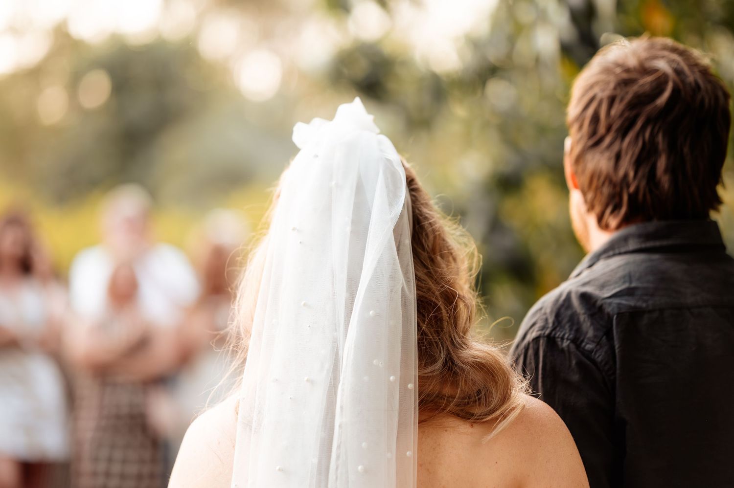 A wedding couple shares intimate moments during their outdoor photo session at golden hour.