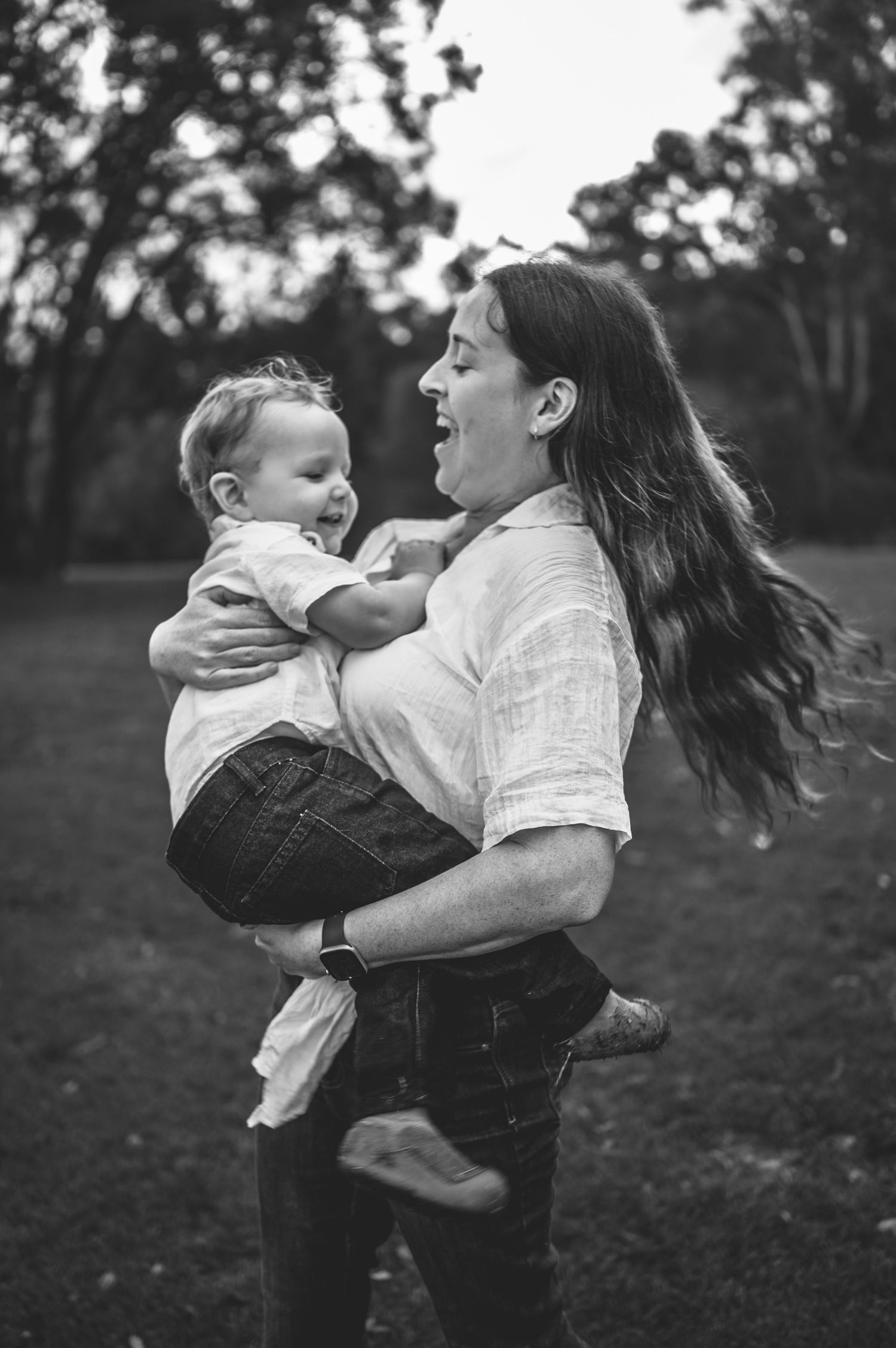 Black and white candid shots of playful moments during a family photoshoot.