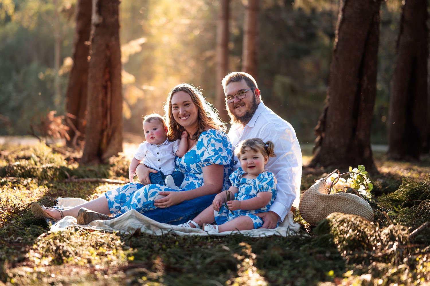 Family enjoying playful moments together during outdoor photo session.