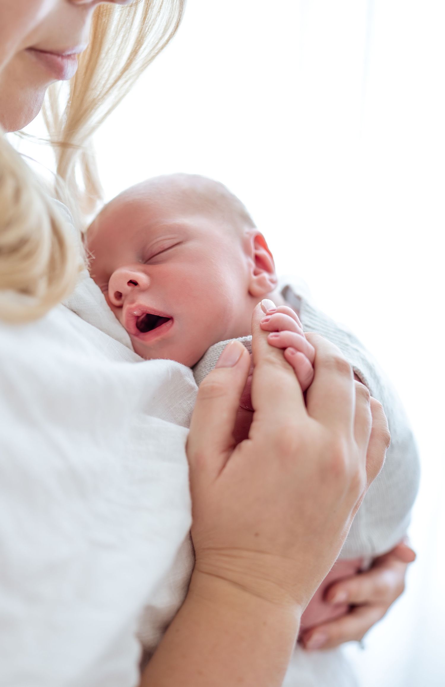 Close-up shots of a baby's expressions against a bright white background.