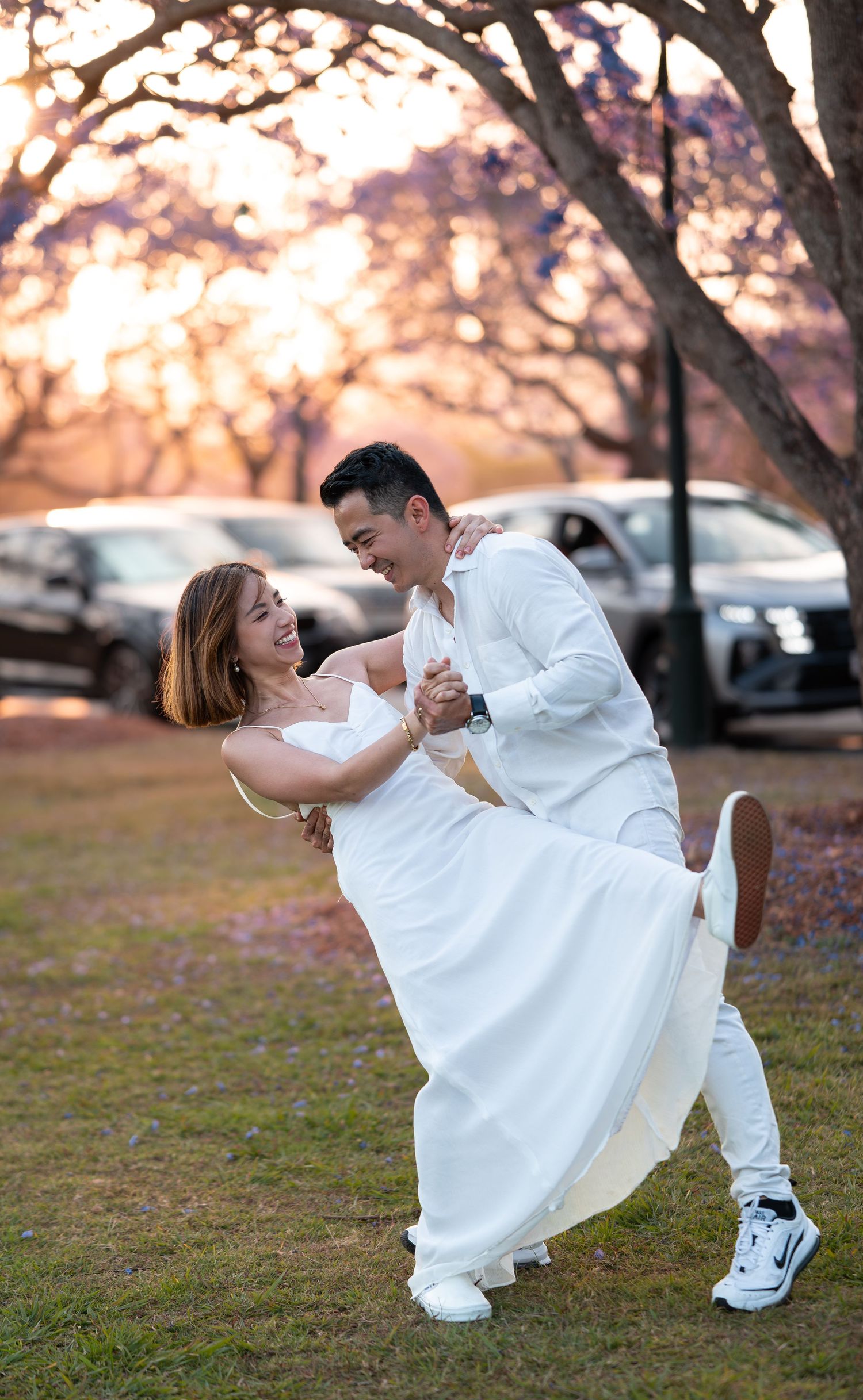 Dancing sequence showing graceful dips and spins in white outfits at sunset.