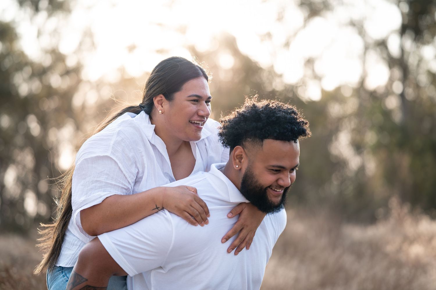 Playful piggyback ride moment captured in a natural outdoor setting.