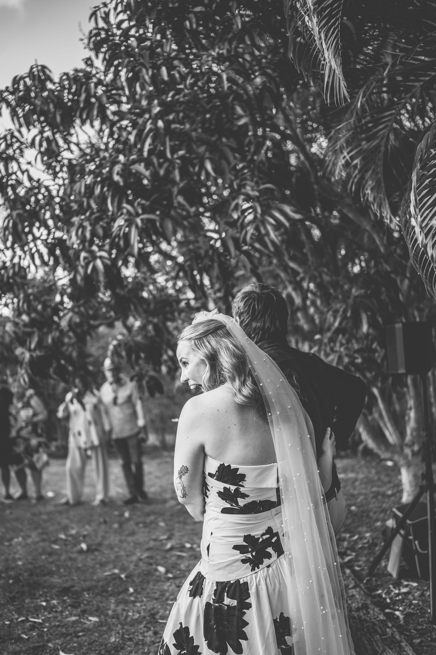 A romantic black and white portrait session in a tropical garden setting.