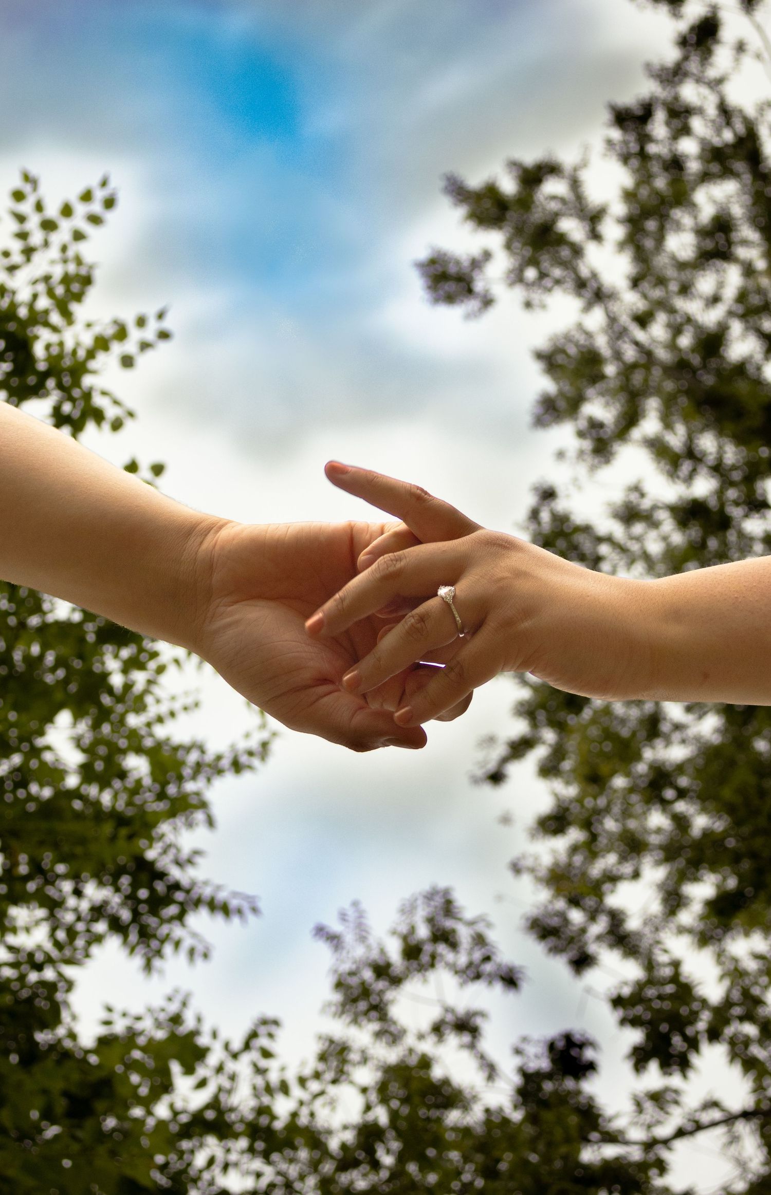Hands holding, camera pointed to the sky.