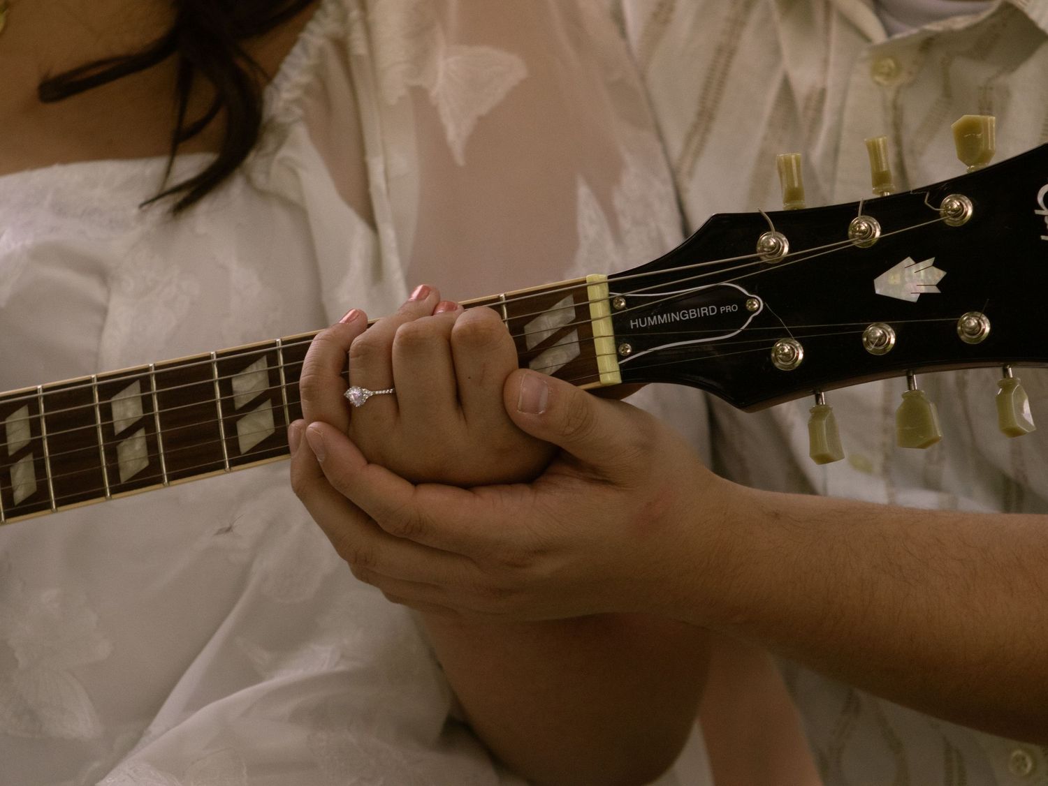 hand holding on guitar