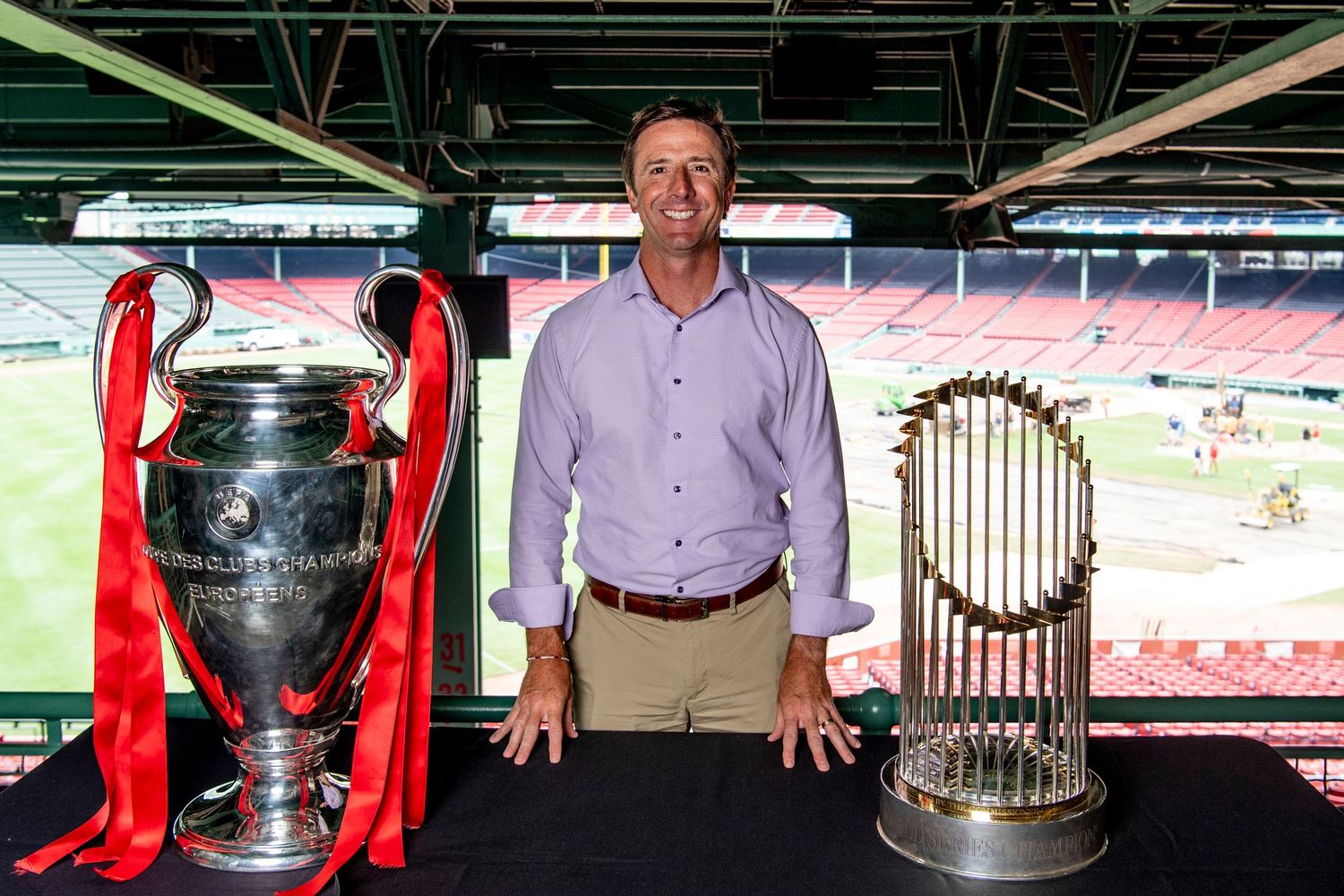 Wide Open Sports photographer Mike Danubio with the UEFA Champions League and World Series trophies