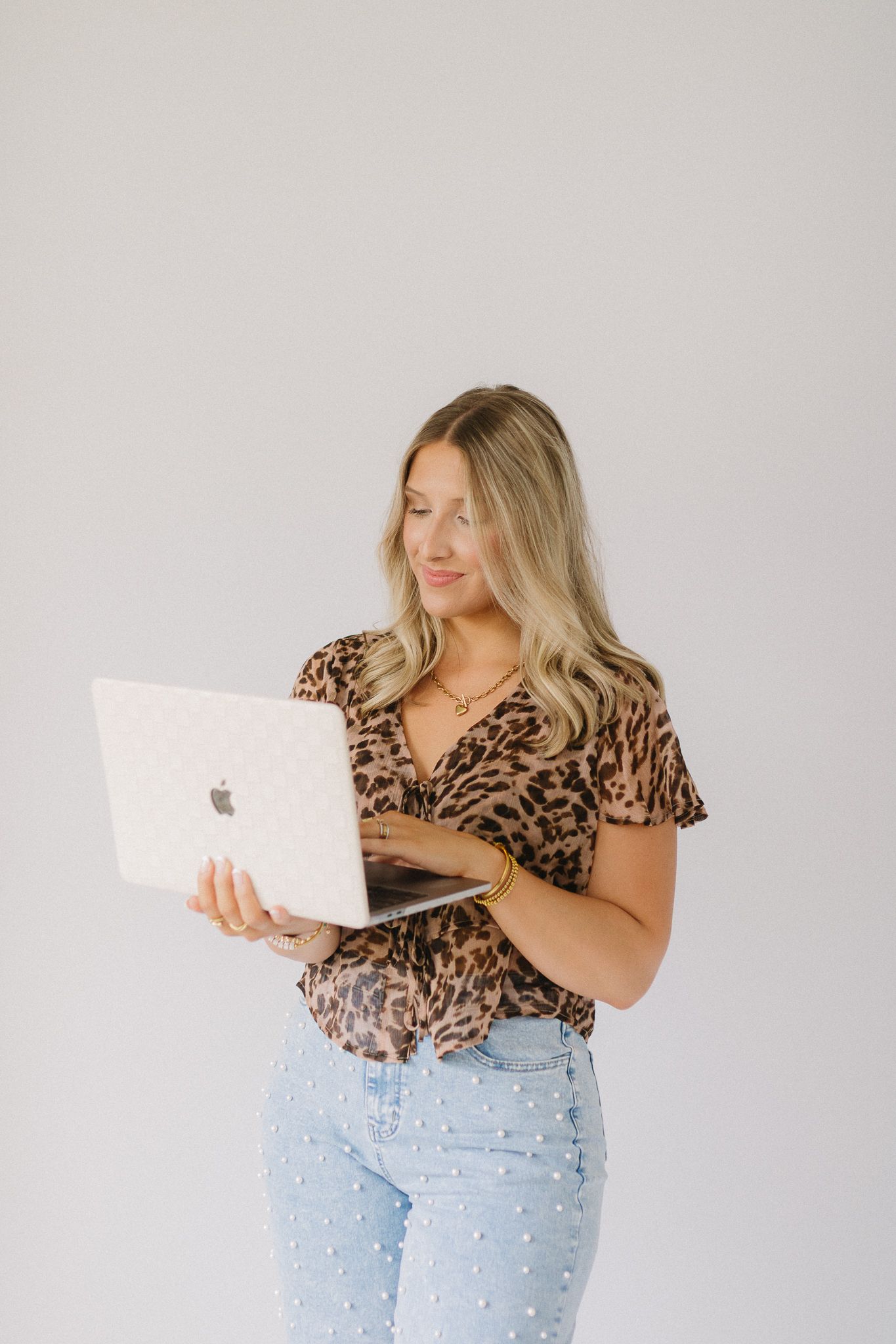 A client of Saylor Heirloom Photography in a professional branding session holding their computer.