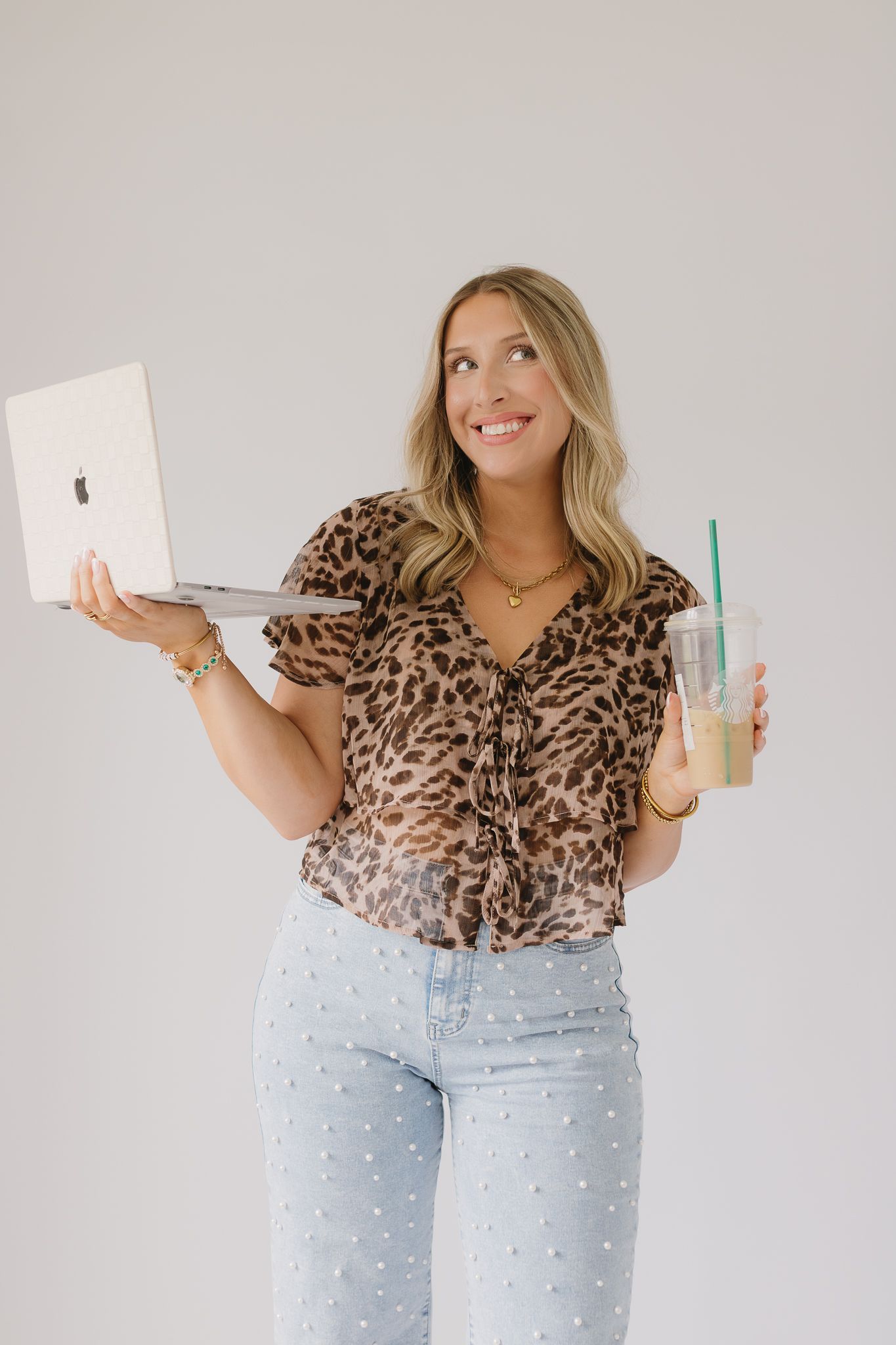 A client of Saylor Heirloom Photography in a professional branding session holding a computer and coffee representing their personality.