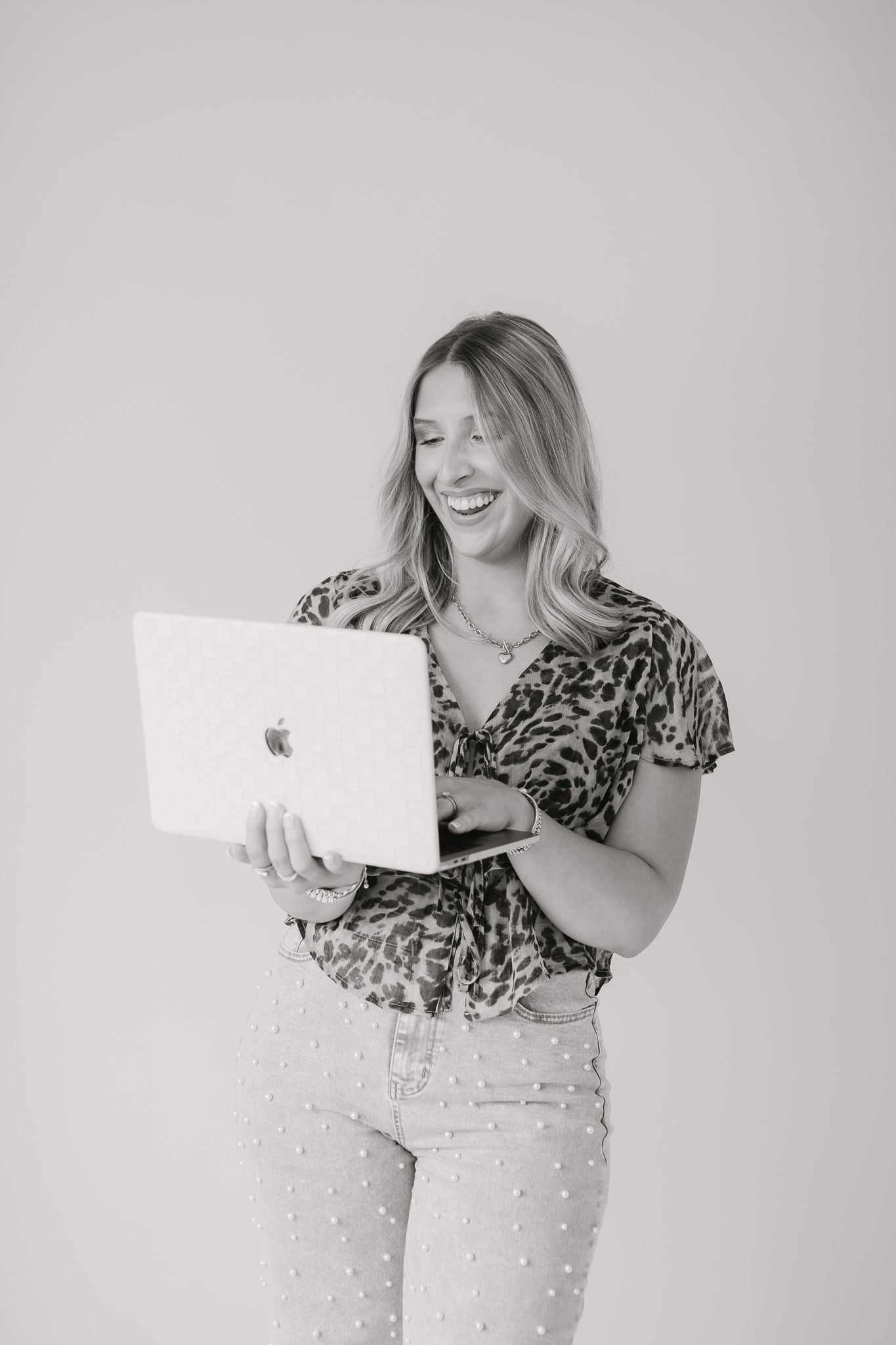 A client of Saylor Heirloom Photography in a professional branding session holding their computer.