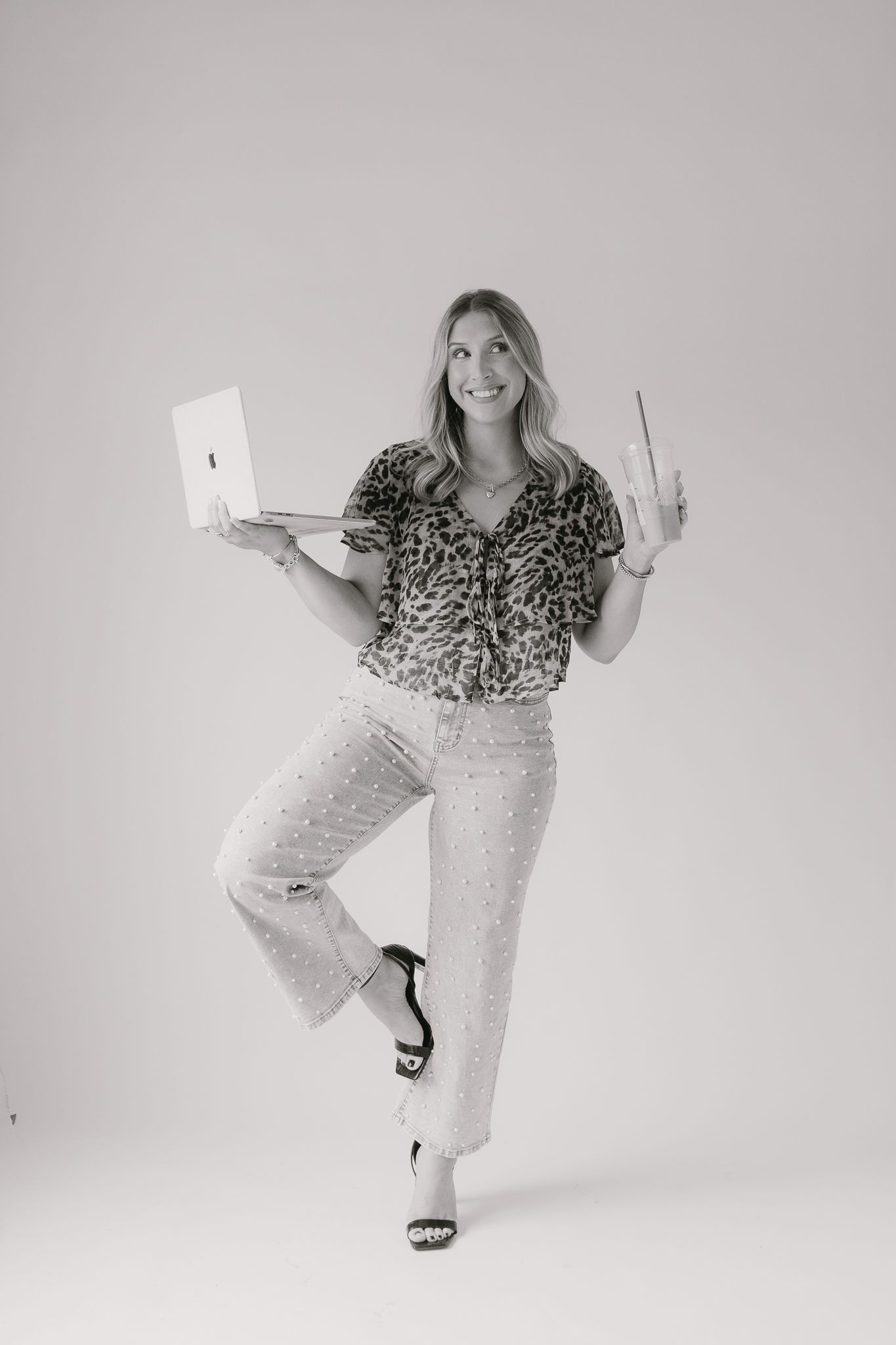 A client of Saylor Heirloom Photography in a professional branding session holding a computer and coffee.