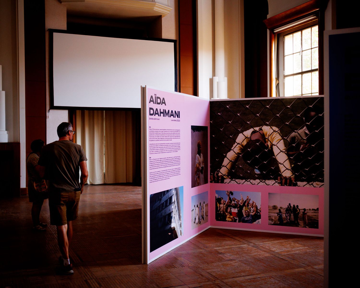 Aida Dahmani photography exhibition display panel inside historic building at Perpignan festival.