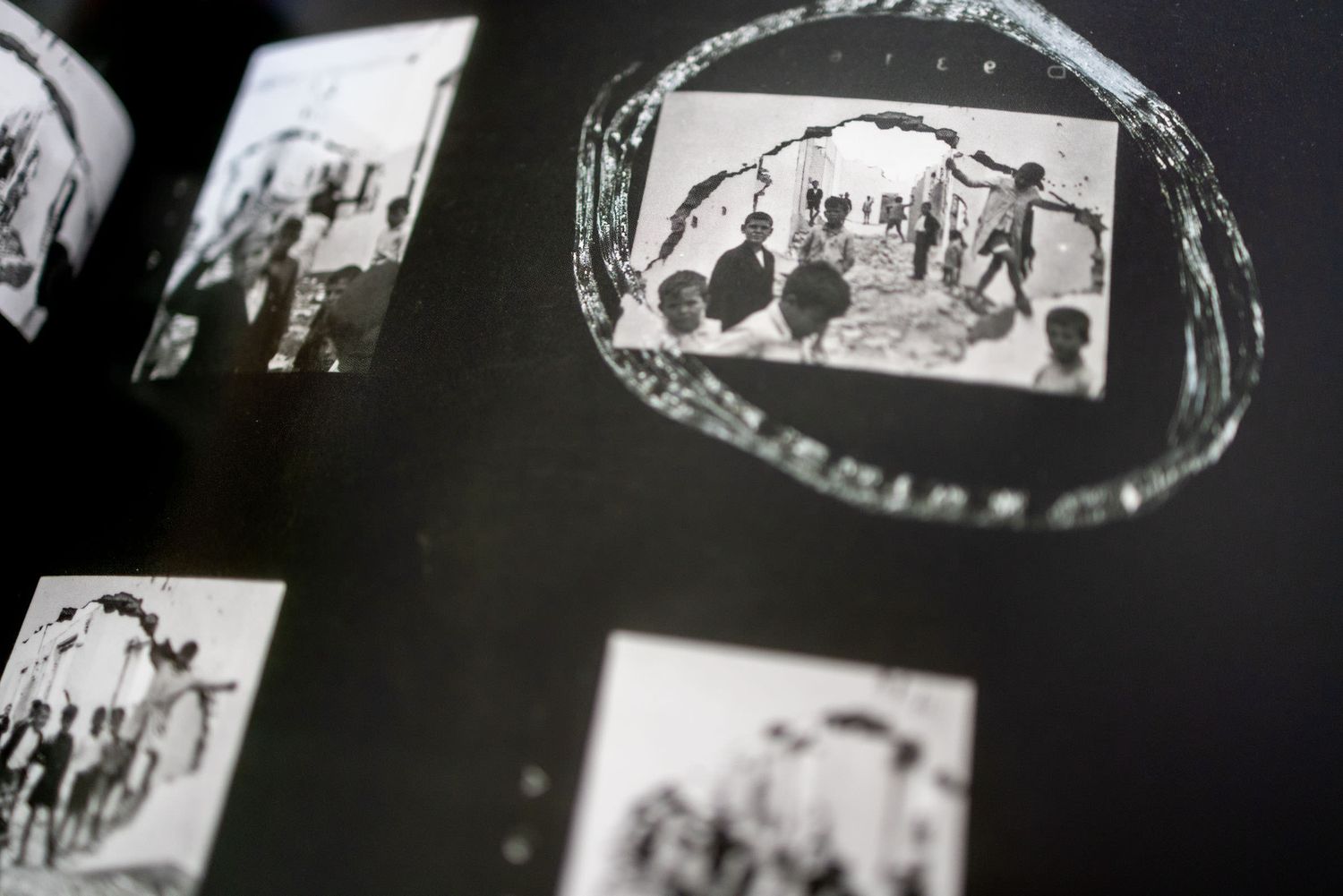 Black and white contact sheet photos showing people gathered under an archway, with one image circled in ink.