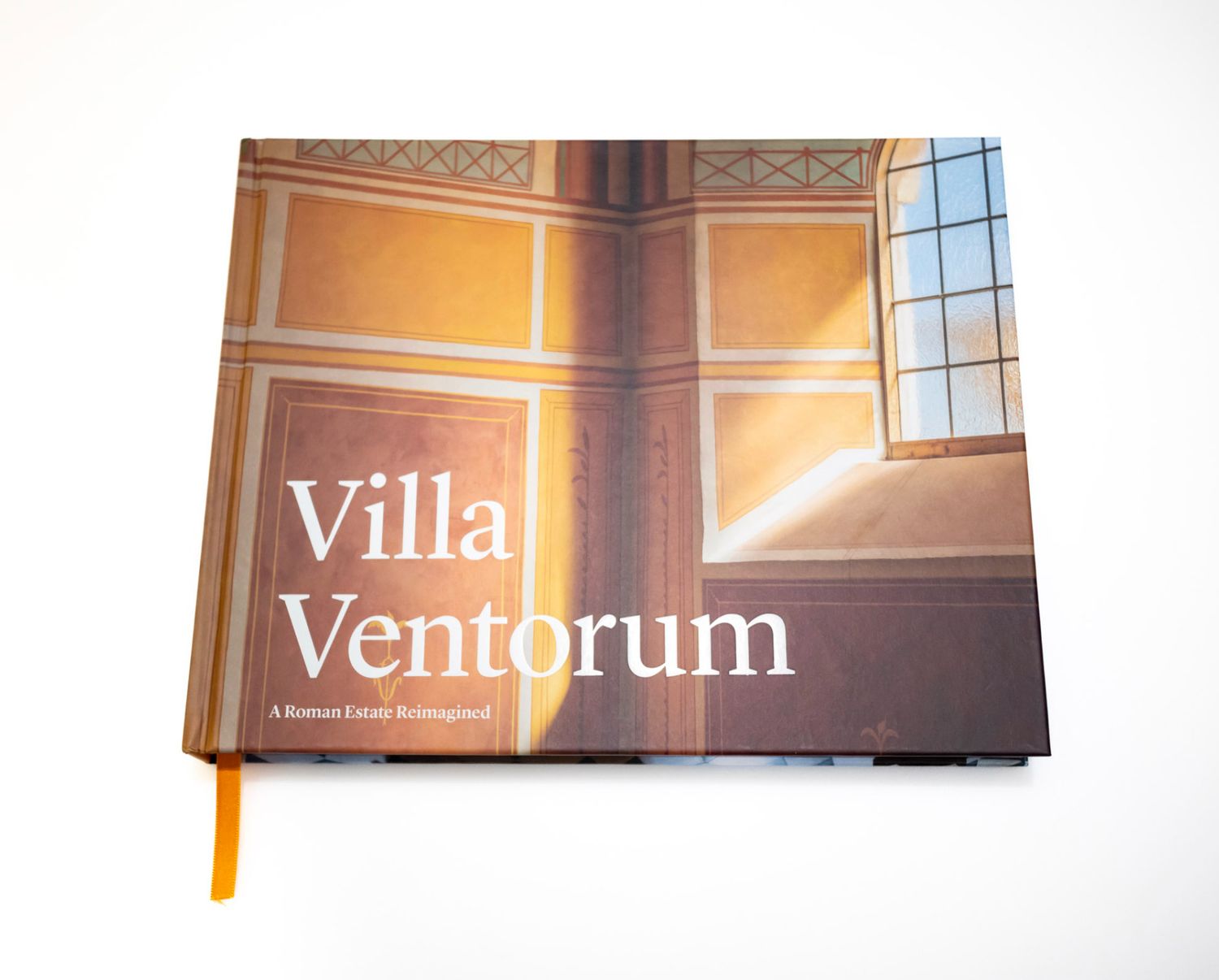 Villa Ventorum hardcover book featuring a Roman estate interior with ornate frescoed walls and natural window light.