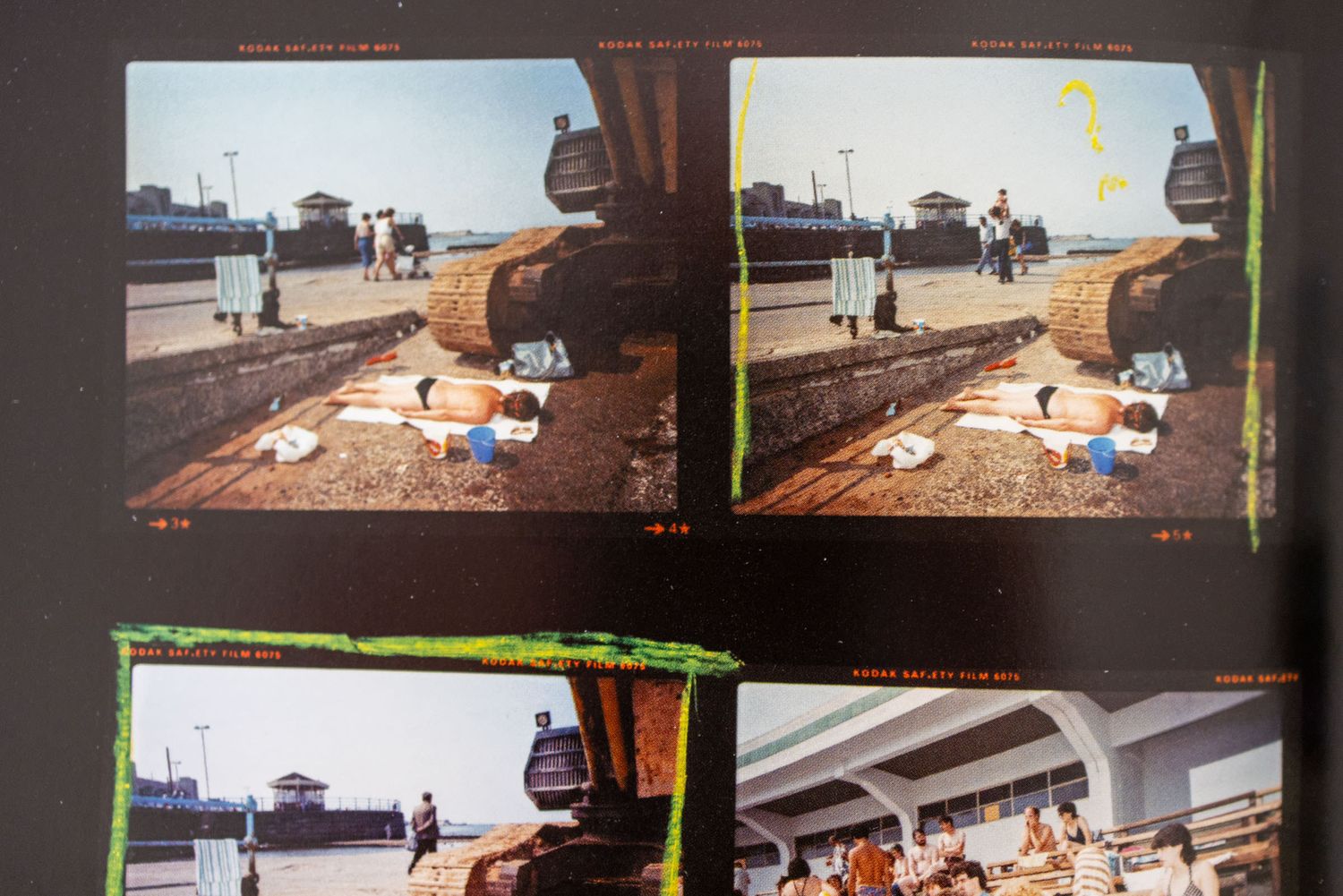 Contact sheet showing multiple film photographs of people relaxing outdoors near a waterfront promenade.