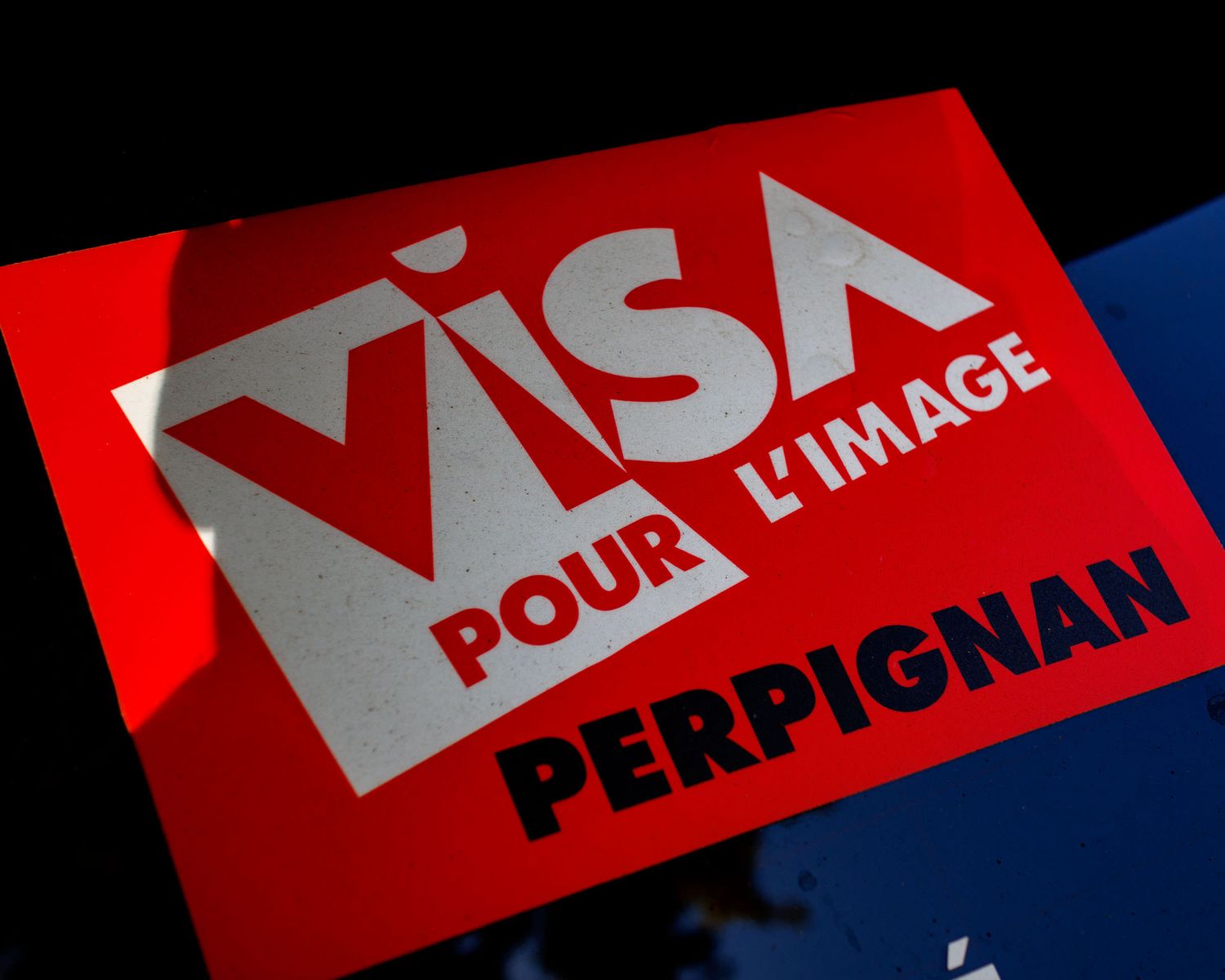 Red Visa Pour L'Image Perpignan photography festival logo sign in bold white text.