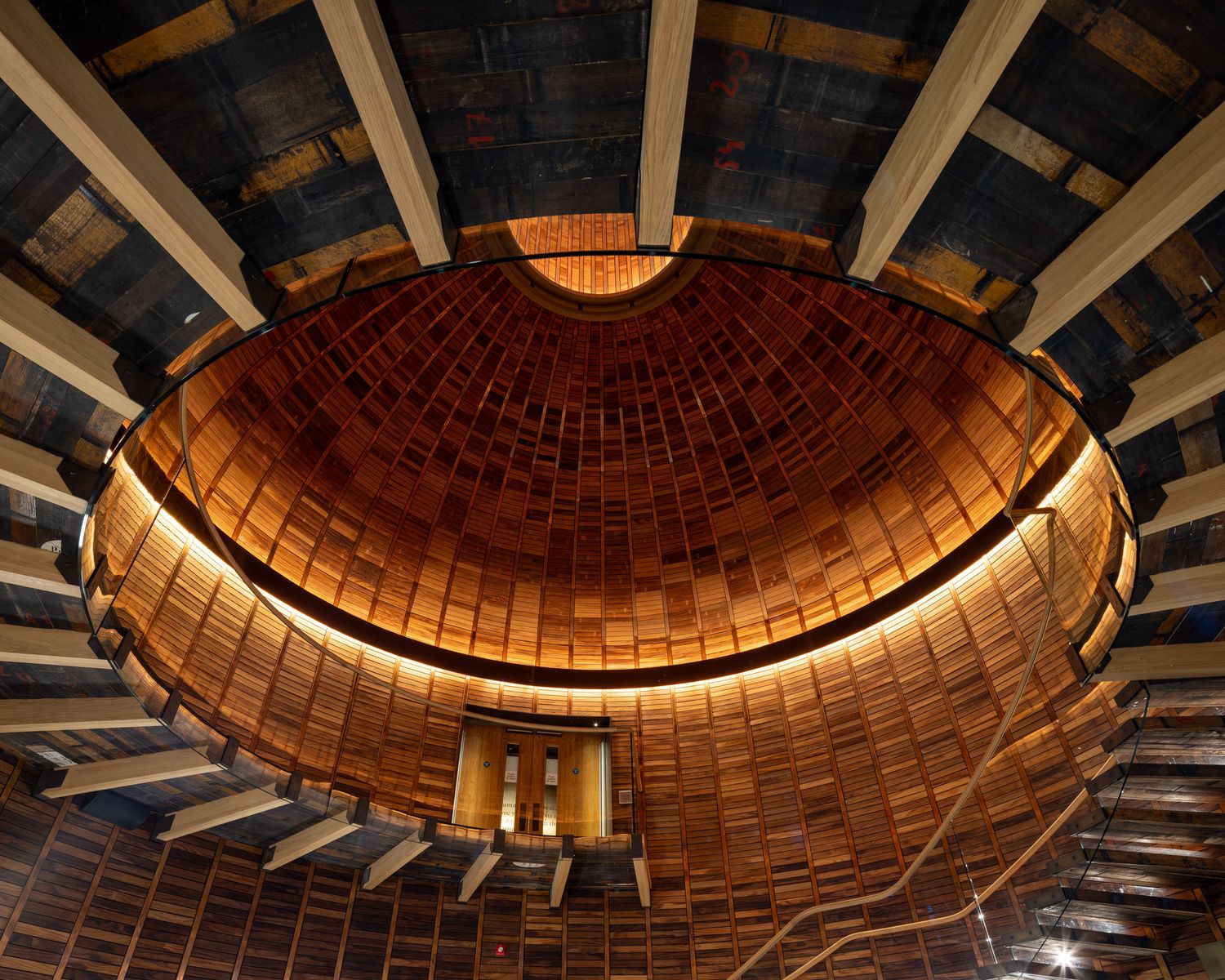 Interior view of a stunning domed wooden ceiling with copper tile mosaic and dramatic uplighting.