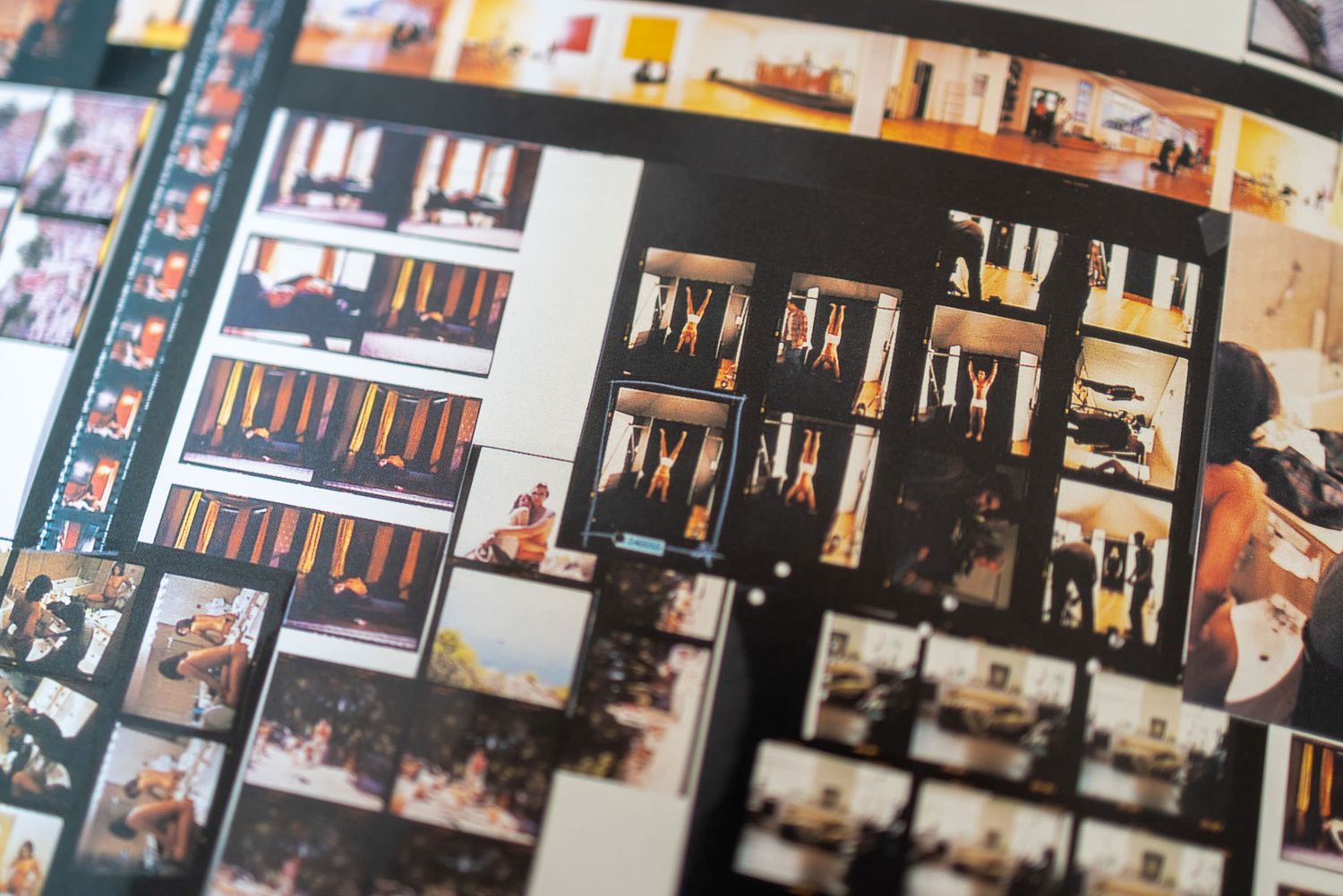 Close-up of a contact sheet displaying multiple small film photographs arranged in rows on a printed page.