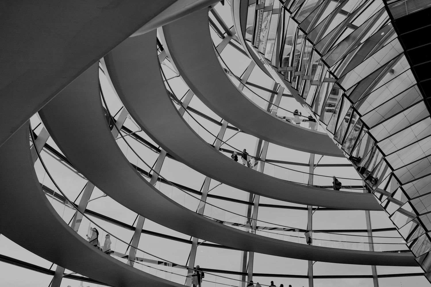 Black and white interior view of the Reichstag dome spiral ramp in Berlin, Germany.