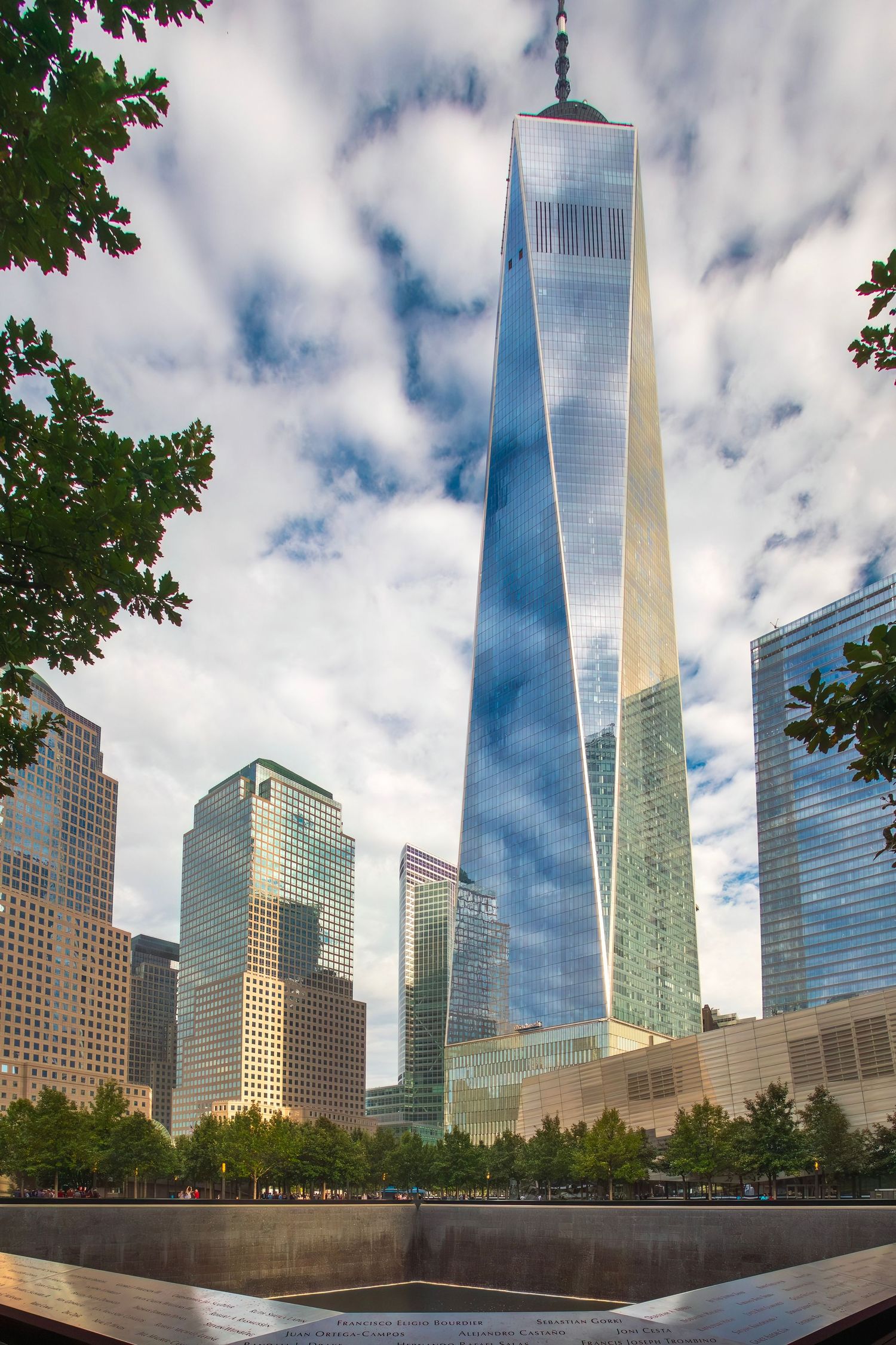 One World Trade Center towers over the 9/11 Memorial reflecting pool in Lower Manhattan, New York City.