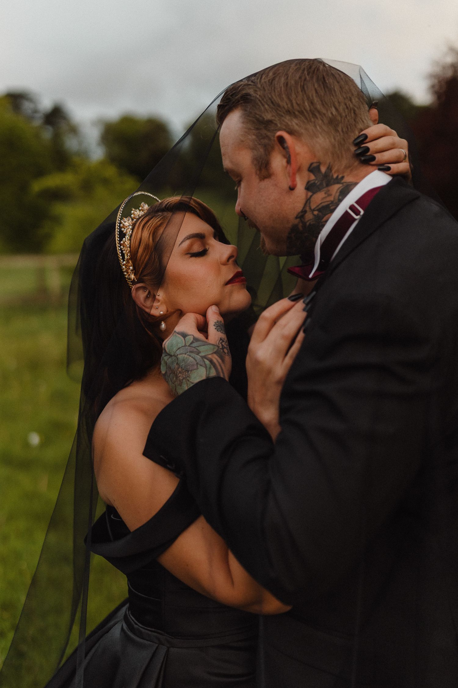 Dark Romance Alternative Style Cornwall Elopement at Scorrier House, Black Wedding Dress outside in Gardens. Lucky Sixpence Crown & Earrings