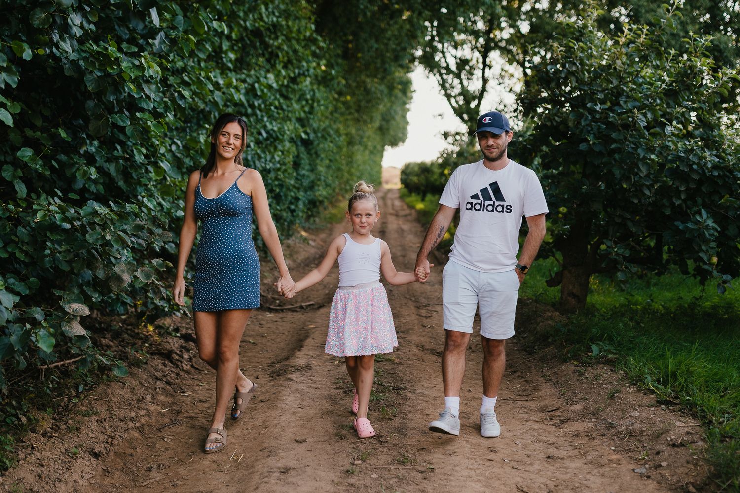 Relaxed family photo session at the farm. Summer evening. Mum Dad & Daughter