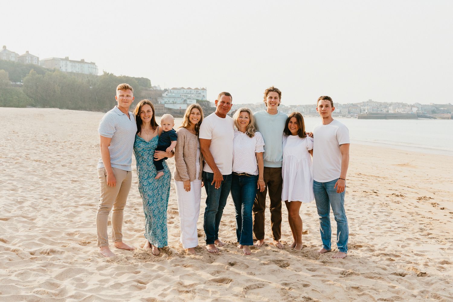 Family photo session on Porthminster Beach, St.Ives, Cornwall. Backlit, golden hour sunset, wearing a blue & white colour palette.