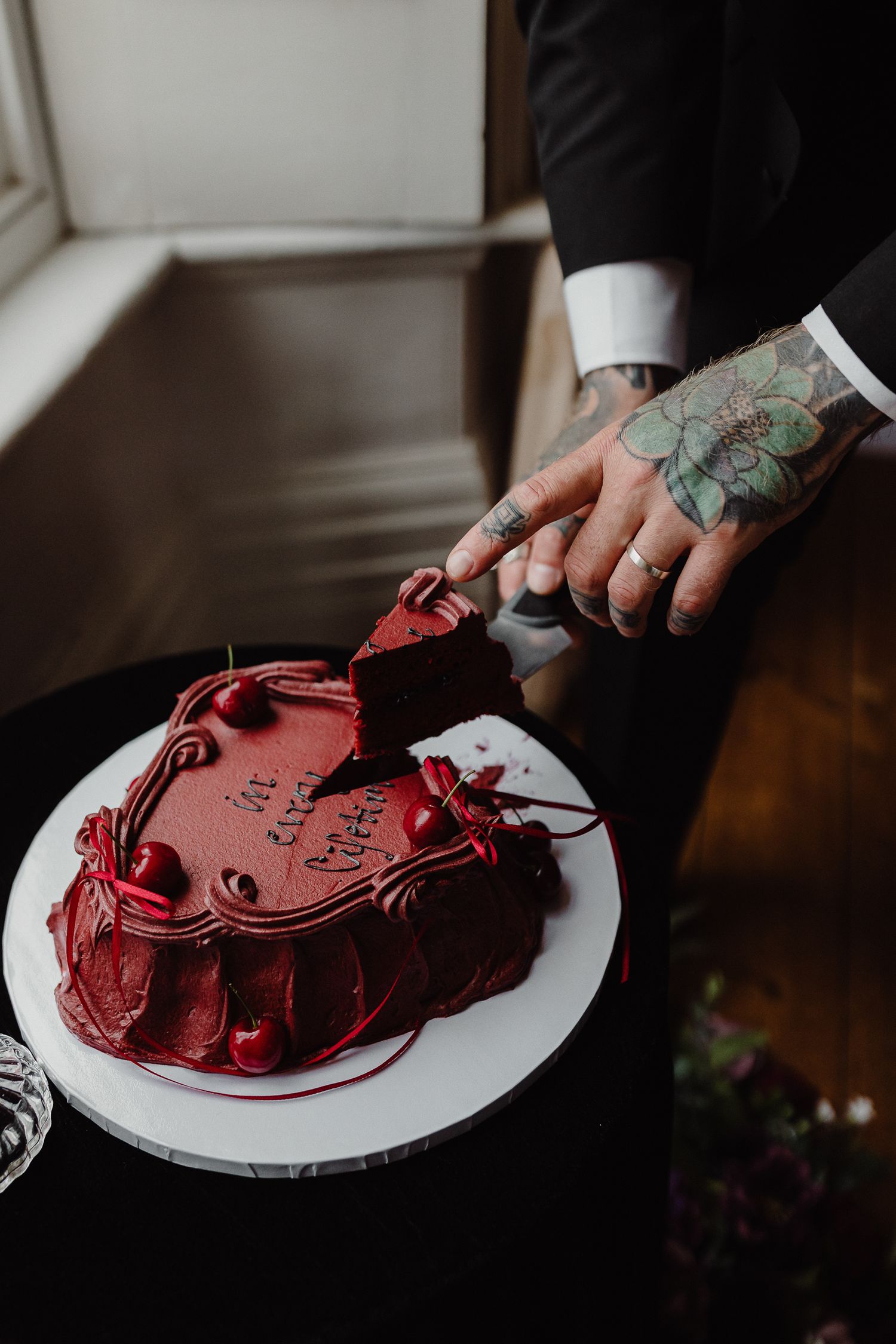 Dark Romance Alternative Style Cornwall Elopement at Scorrier House. Cake cutting Amber's Cakery burgundy wedding cake Drawing Room