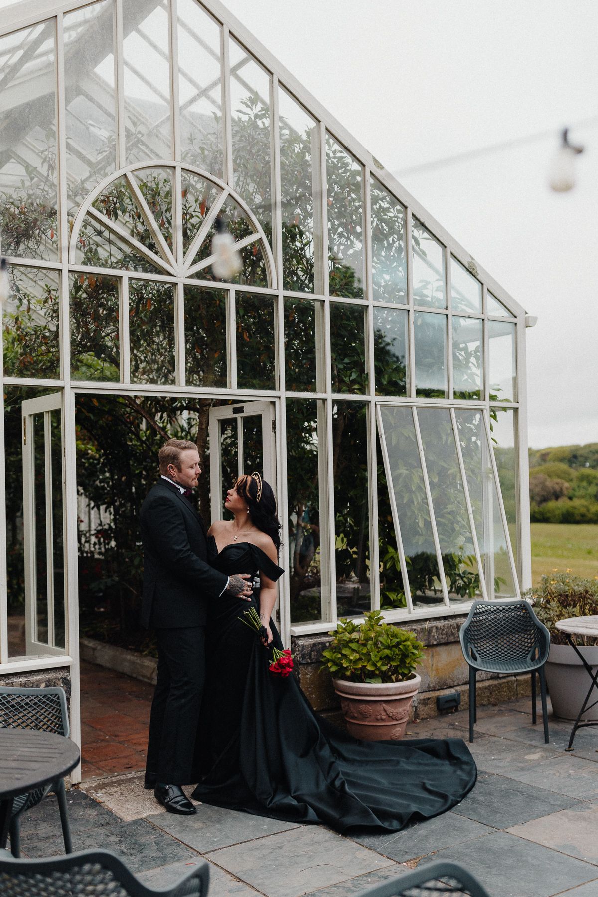Dark Romance Alternative Style Cornwall Elopement at Scorrier House, Black Wedding Dress outside Conservatory