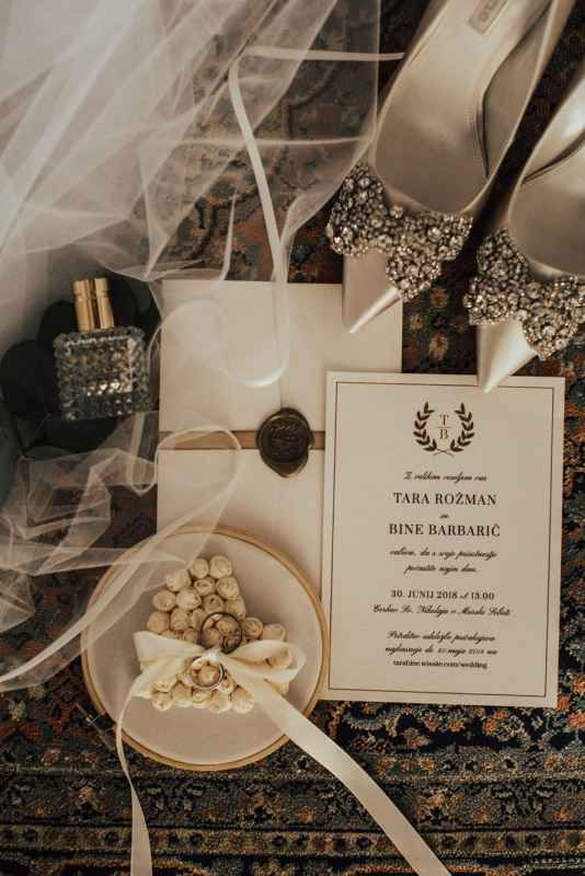 Elegant wedding invitation for Tara Rozman and Bine Barbaric with veil, heels, and bow tie accessories.