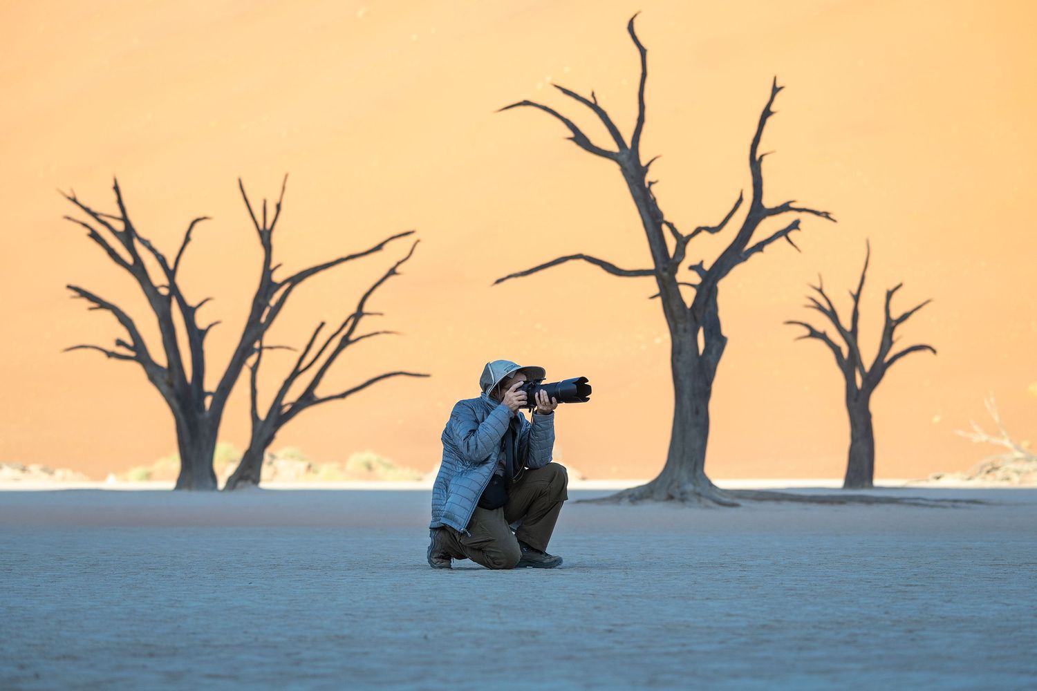Diana Rebman photographing among the dead camel thorn trees at Deadvlei, Namibia.