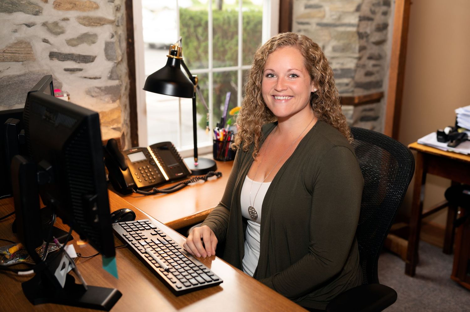 Business professional working at a desk during a personal branding photography session.