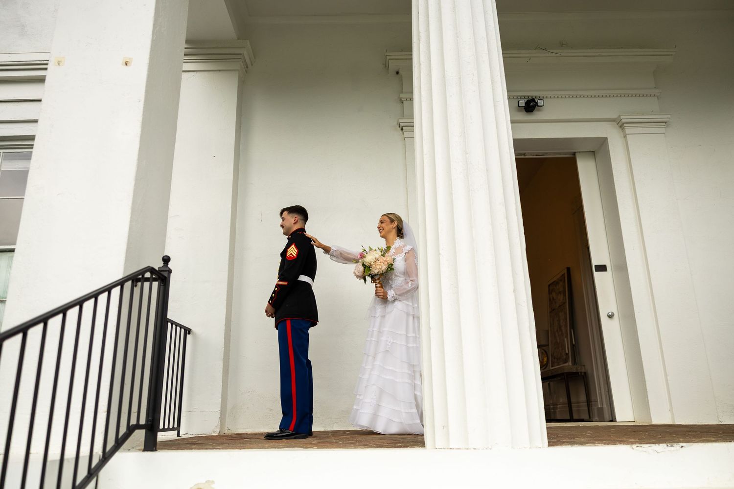 a bride tapping her groom on the shoulder