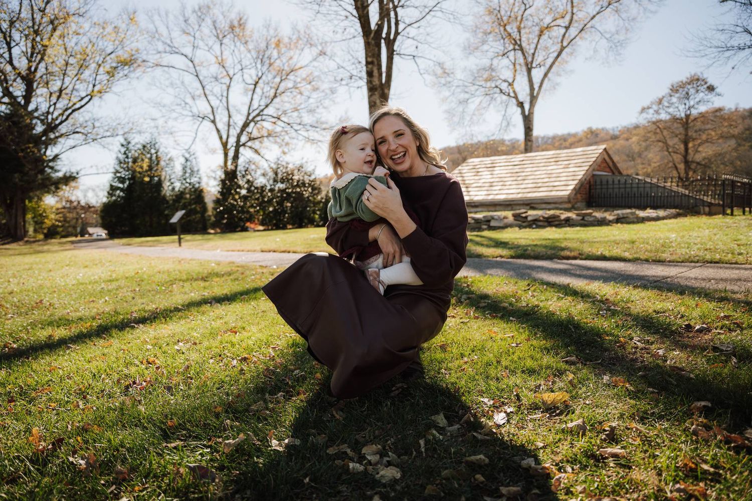 a mom holding her baby daughter
