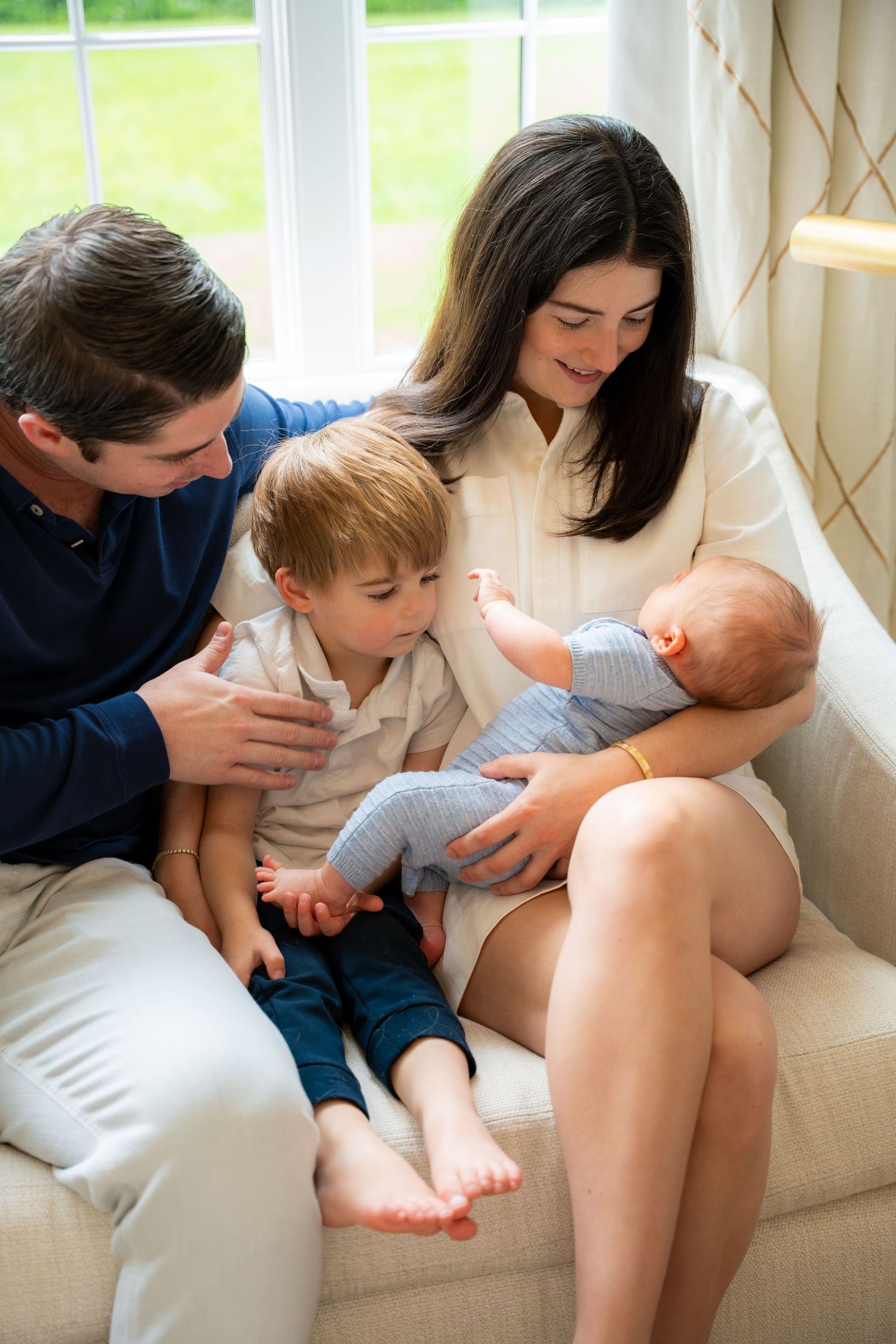 a family holding a new born baby during their family photo session