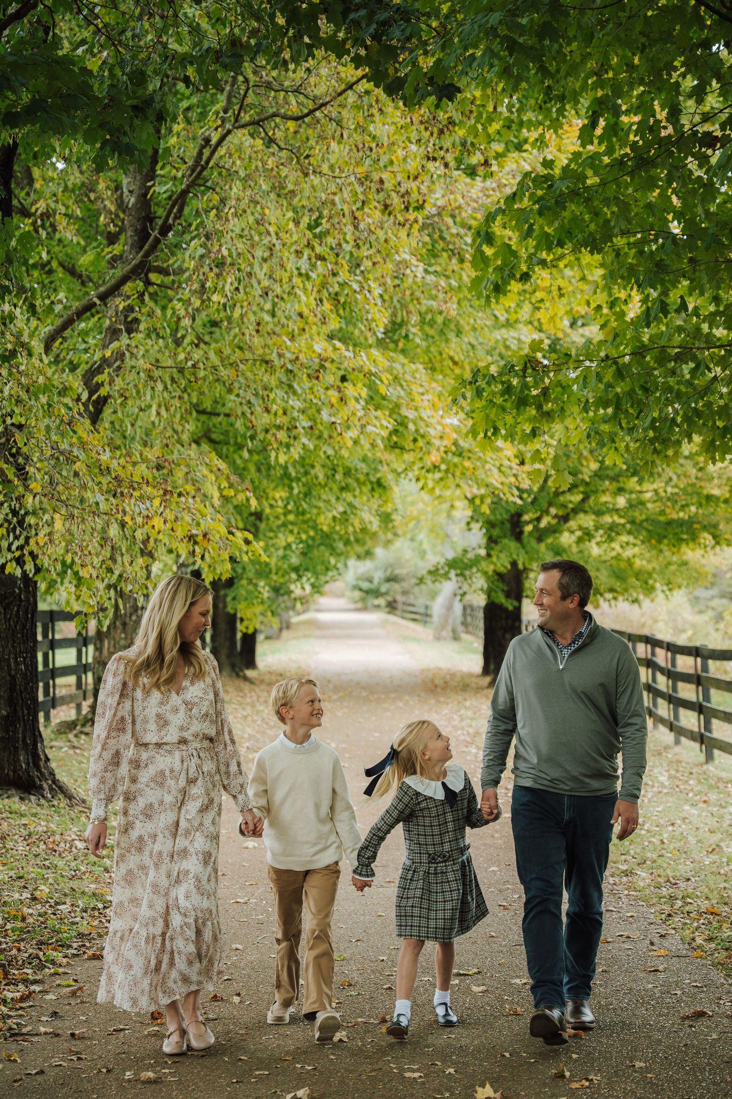 a family walking holding hands and laughing