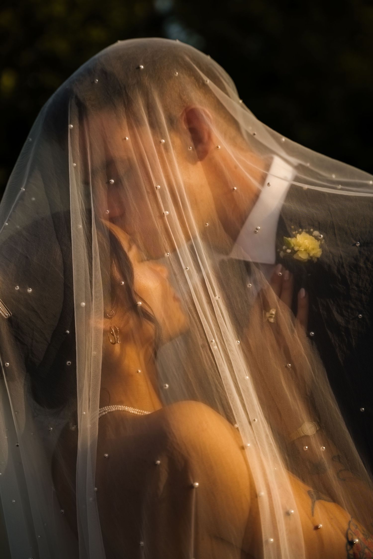couple kissing under a veil