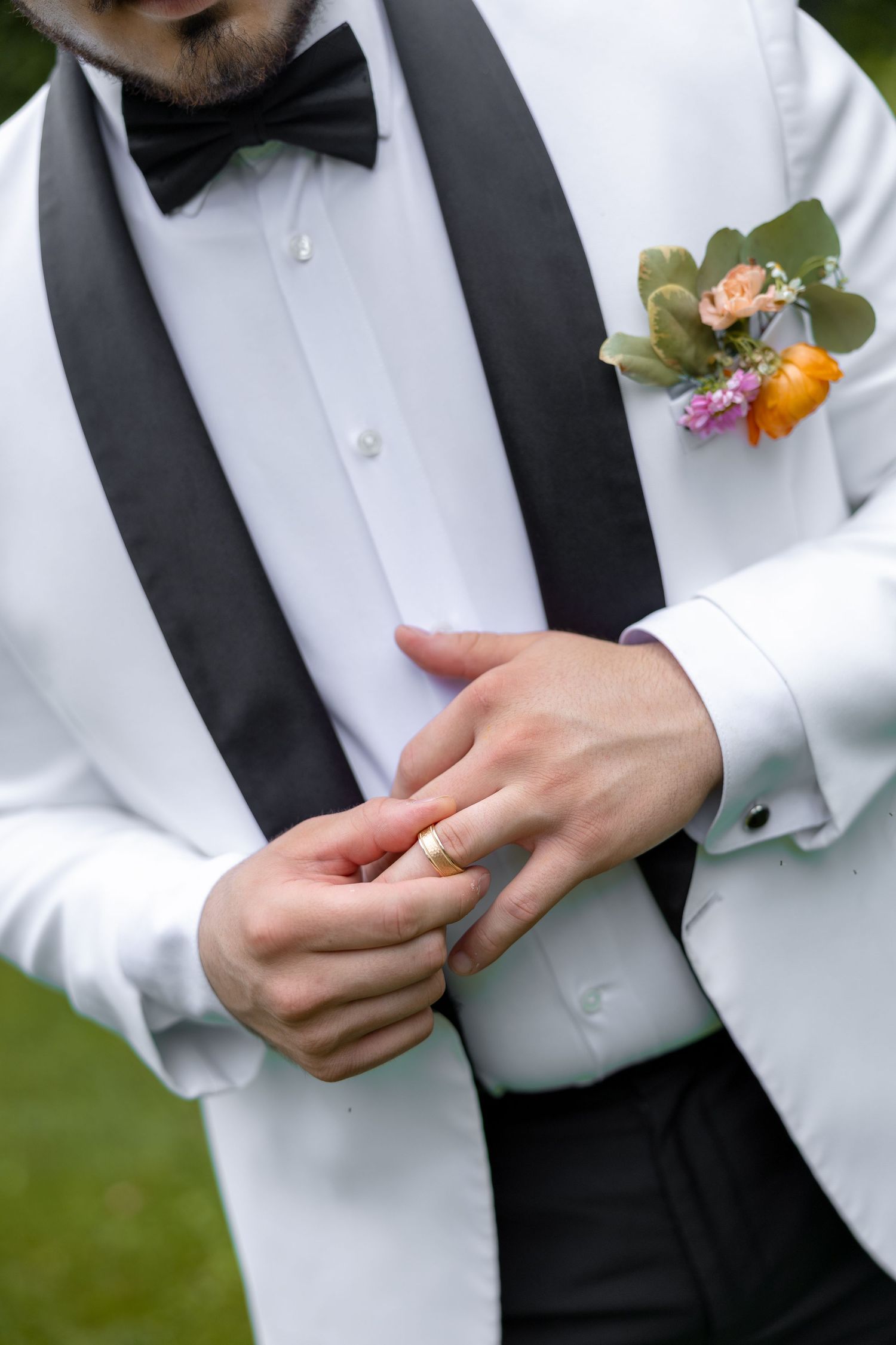 a groom playing with his ring on his wedding day