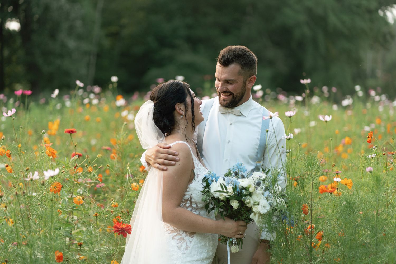 couple kissing in a grassy field
